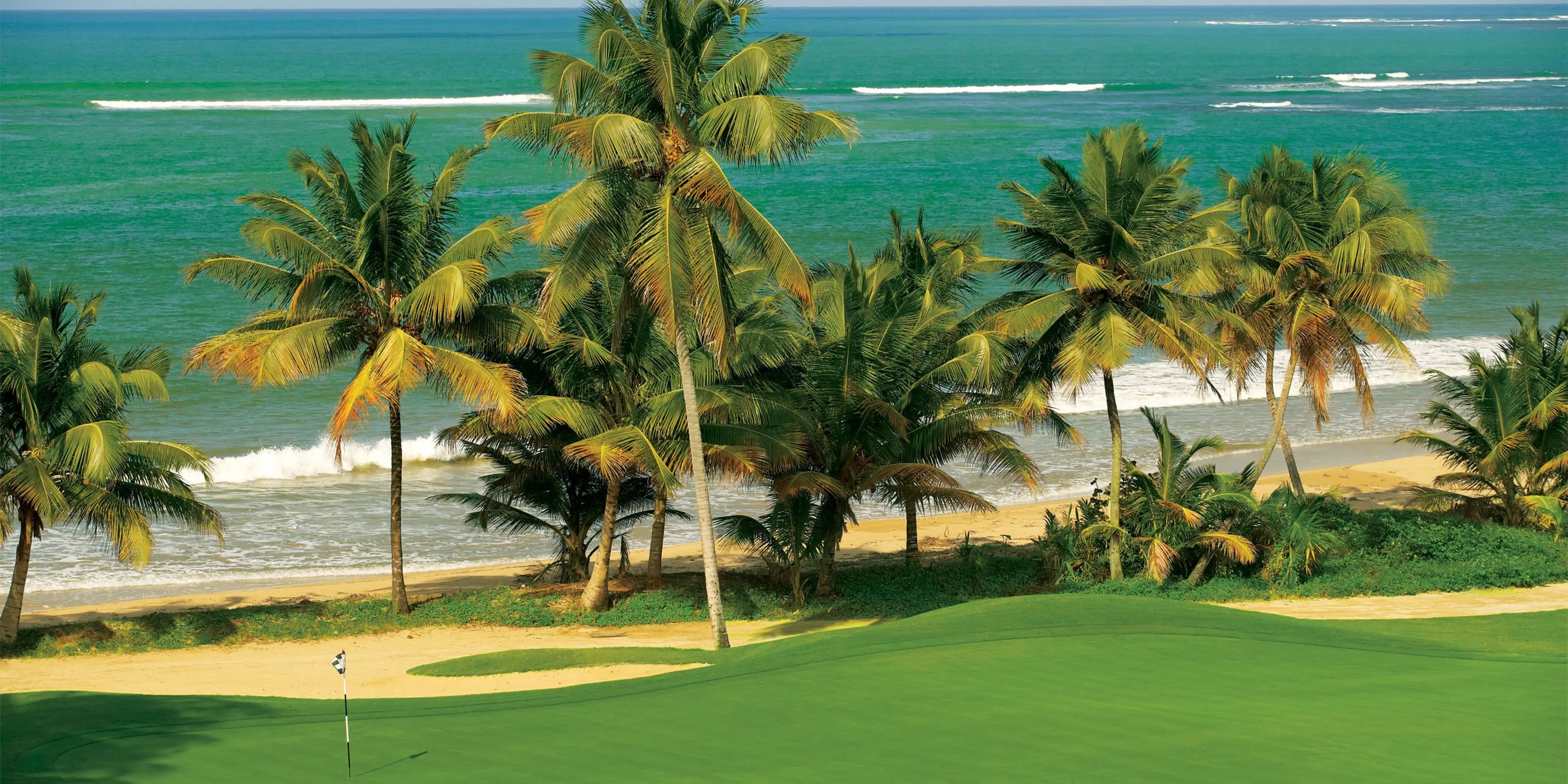 Landscape putting greens and fairway photo of the Bahia Beach Resort & Golf Club golf course