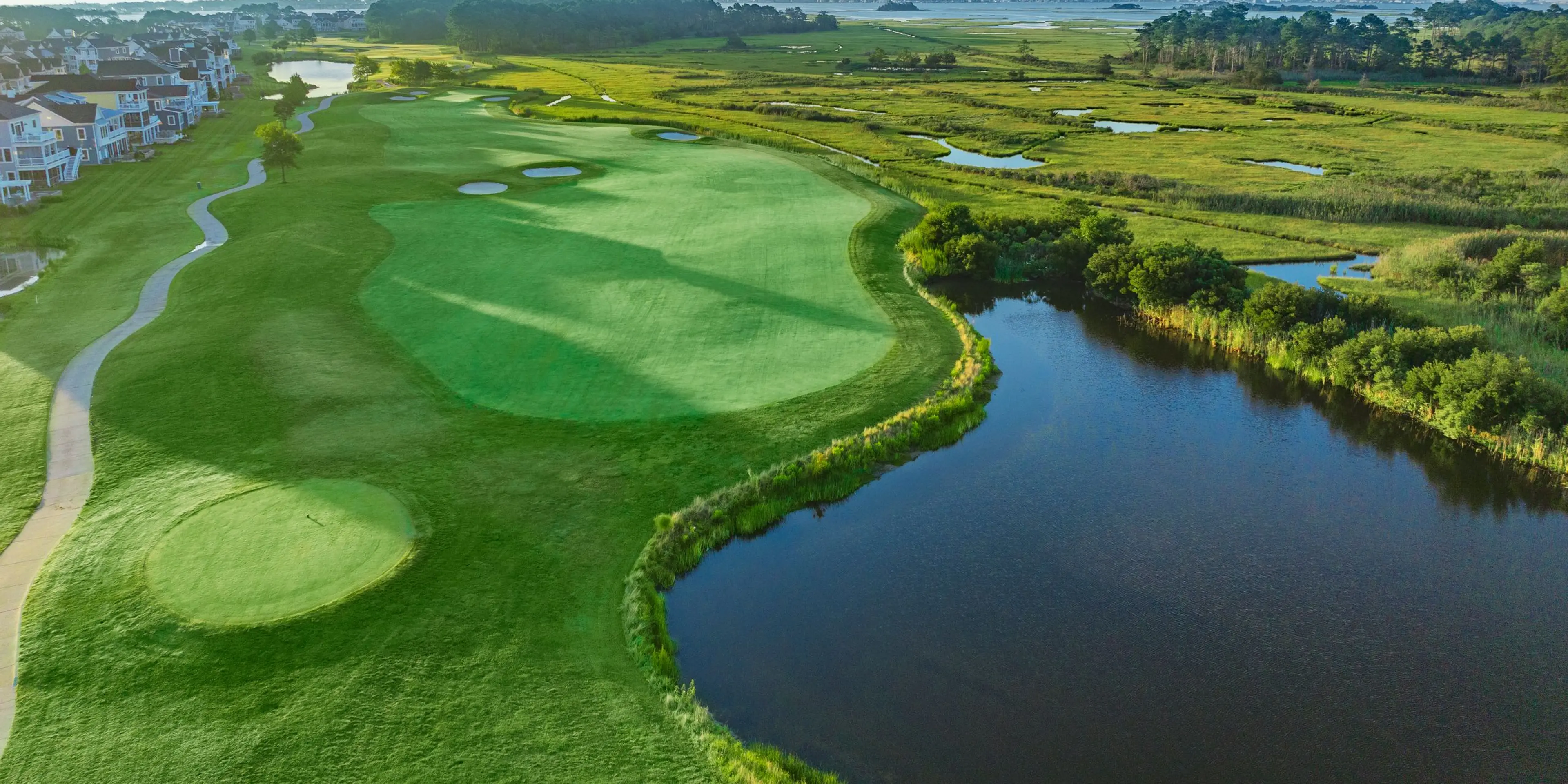 Landscape putting greens and fairway photo of the Bayside Resort Golf Club golf course