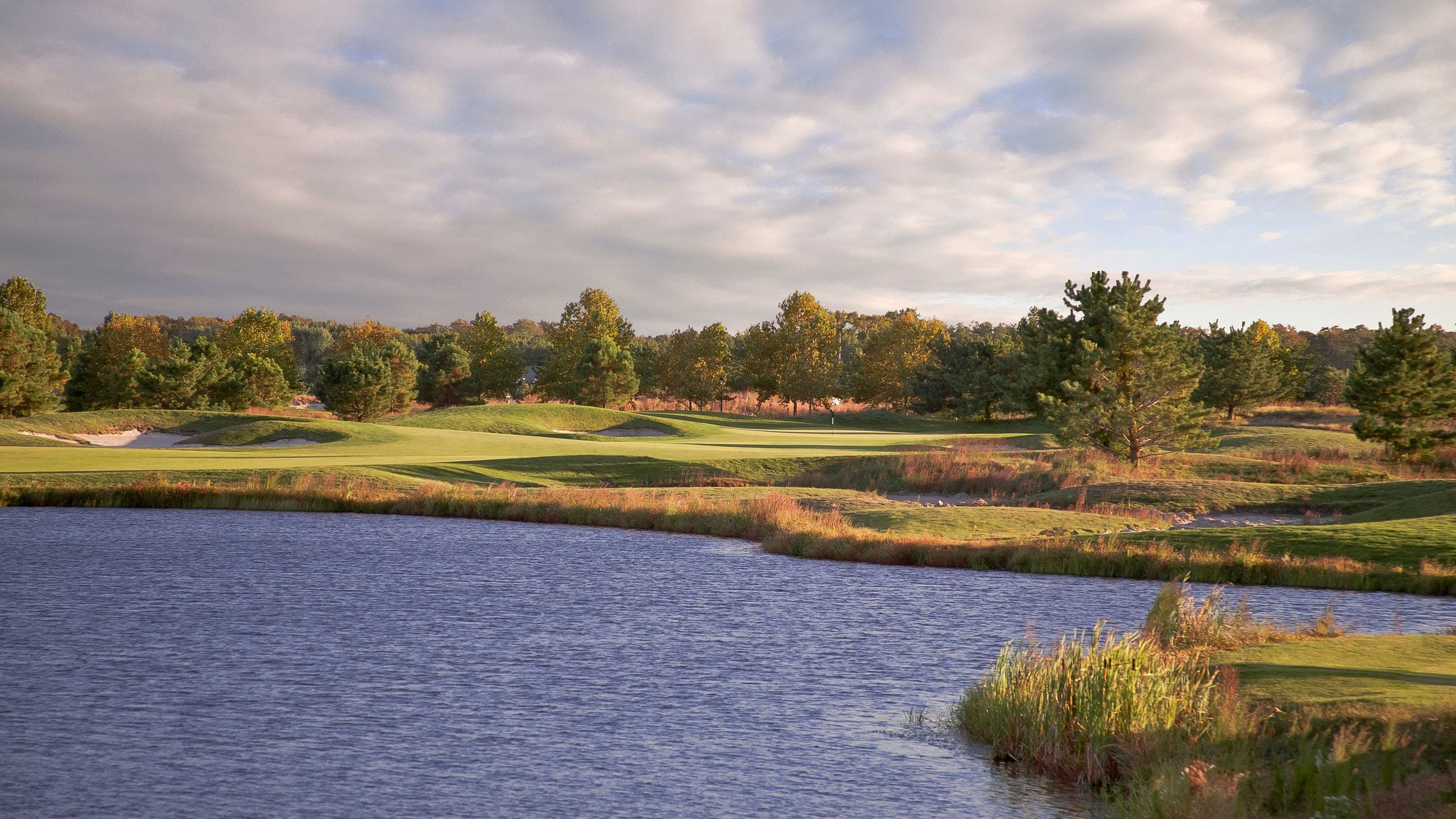Landscape putting greens and fairway photo of the Bear Trap Dunes Golf Club golf course
