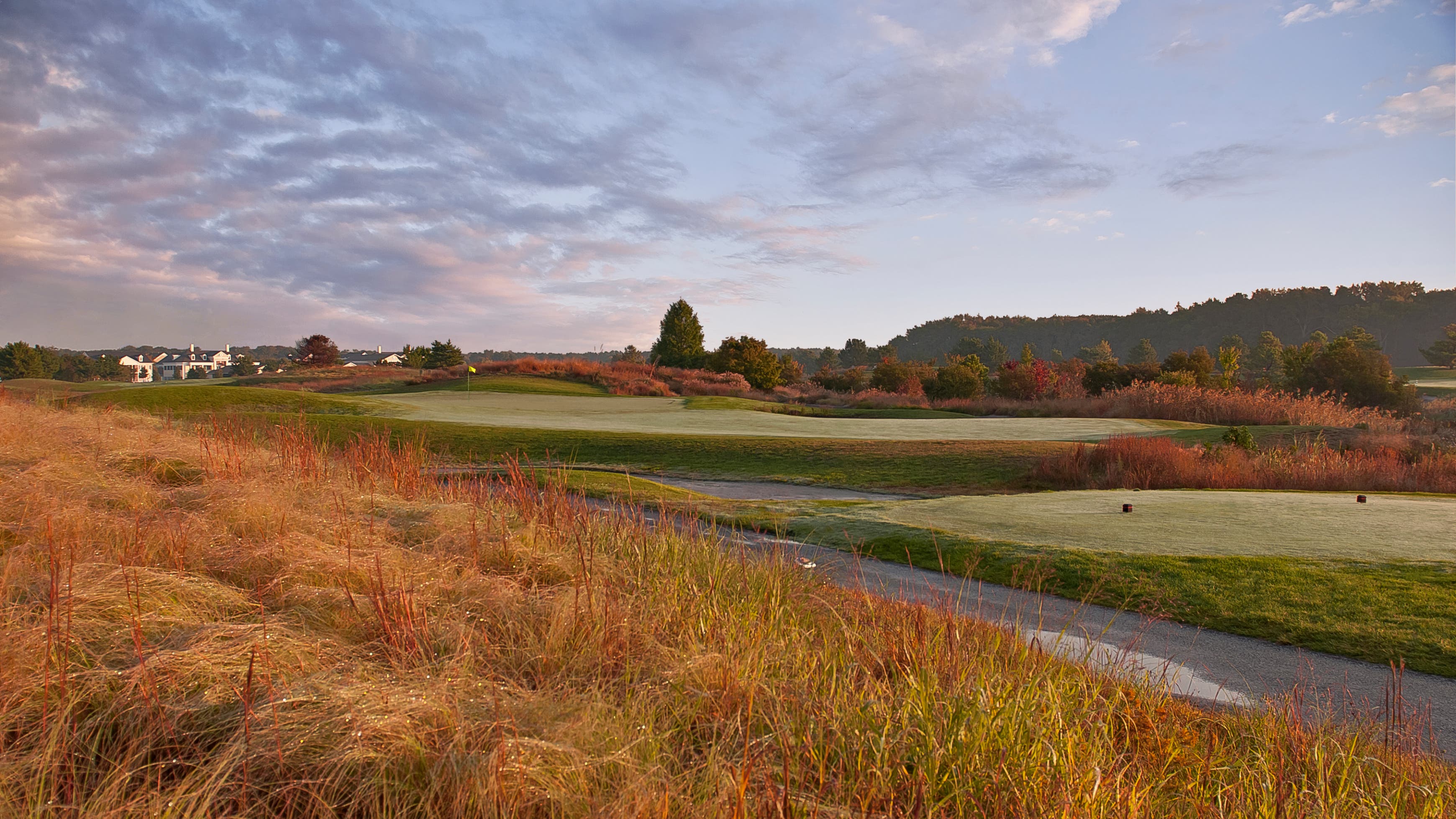 Landscape putting greens and fairway photo of the Bear Trap Dunes Golf Club golf course