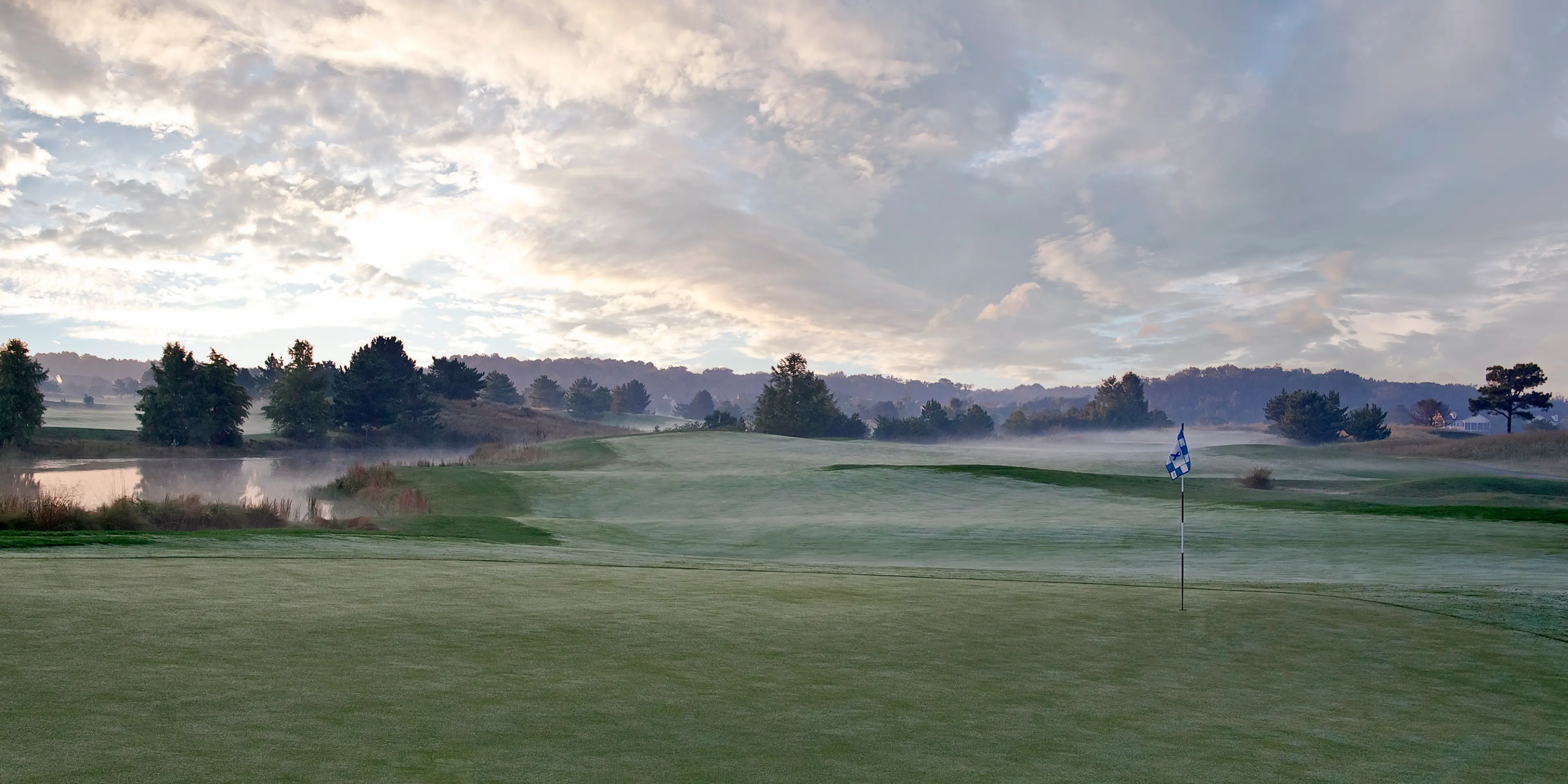Landscape putting greens and fairway photo of the Bear Trap Dunes Golf Club golf course