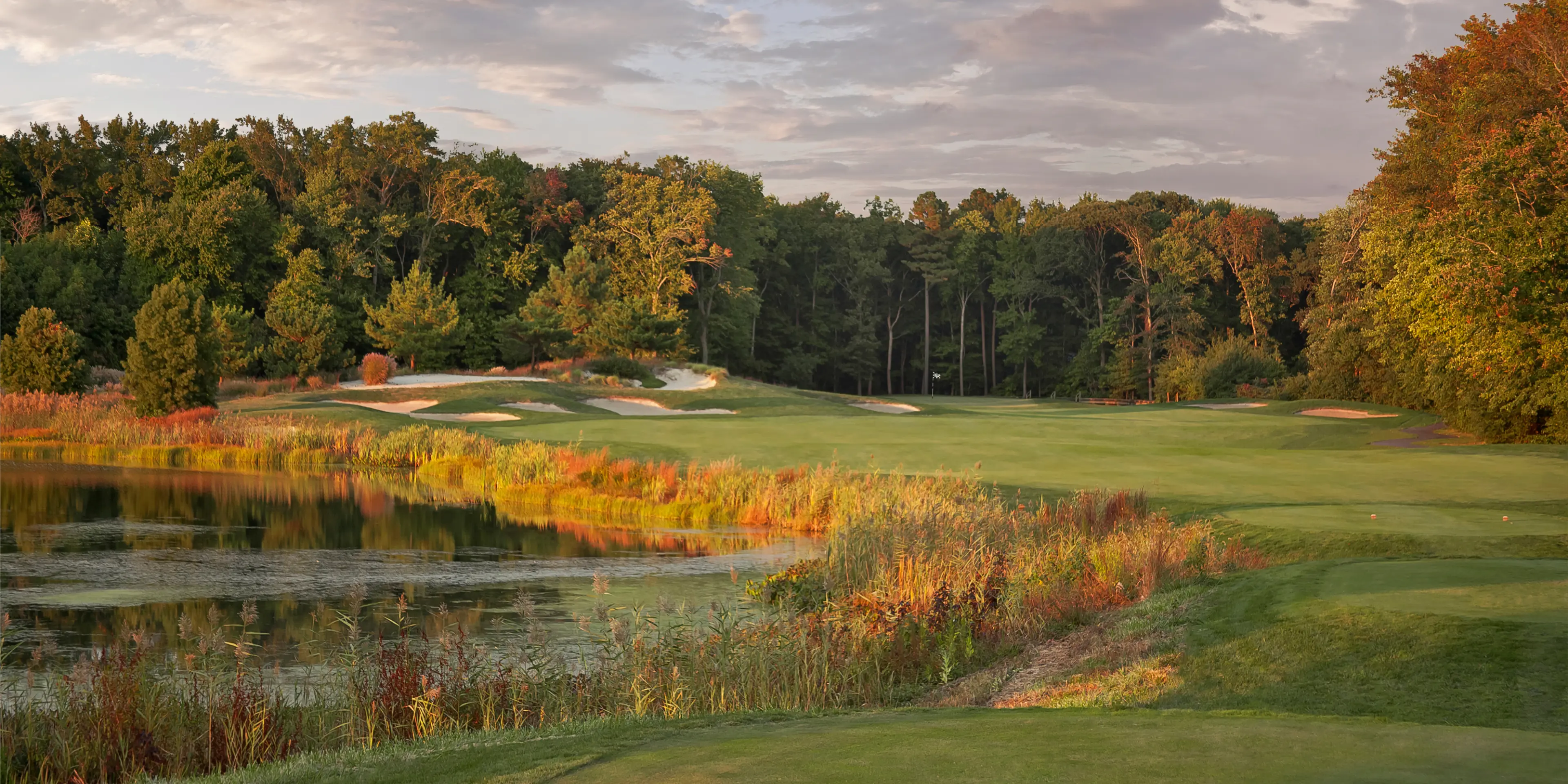 Landscape putting greens and fairway photo of the Bear Trap Dunes Golf Club golf course