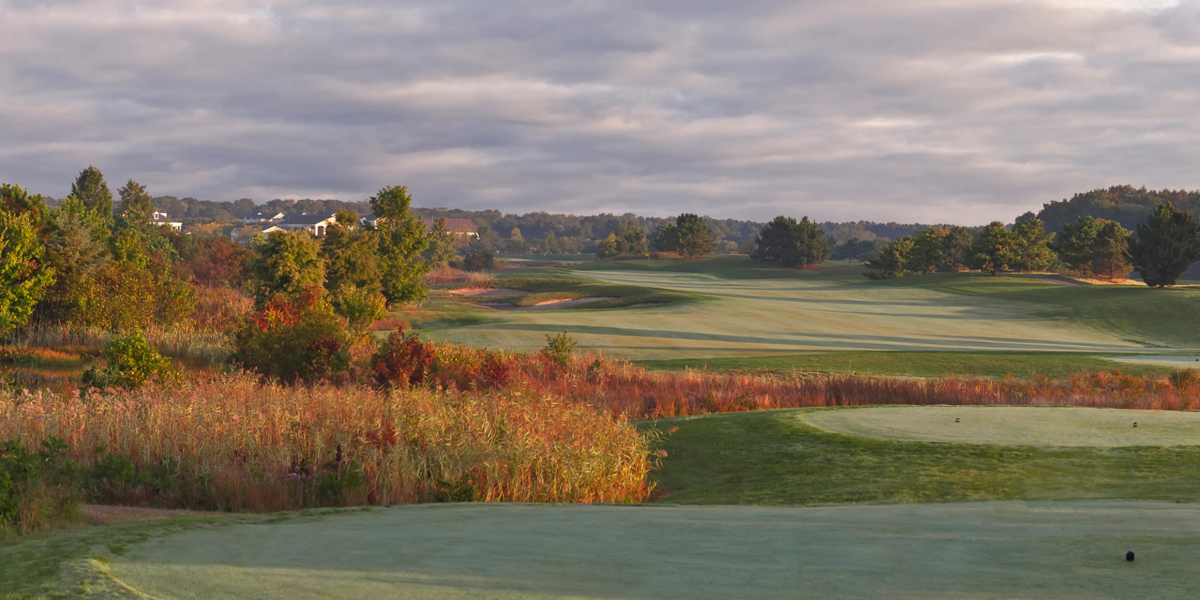 Landscape putting greens and fairway photo of the Bear Trap Dunes Golf Club golf course