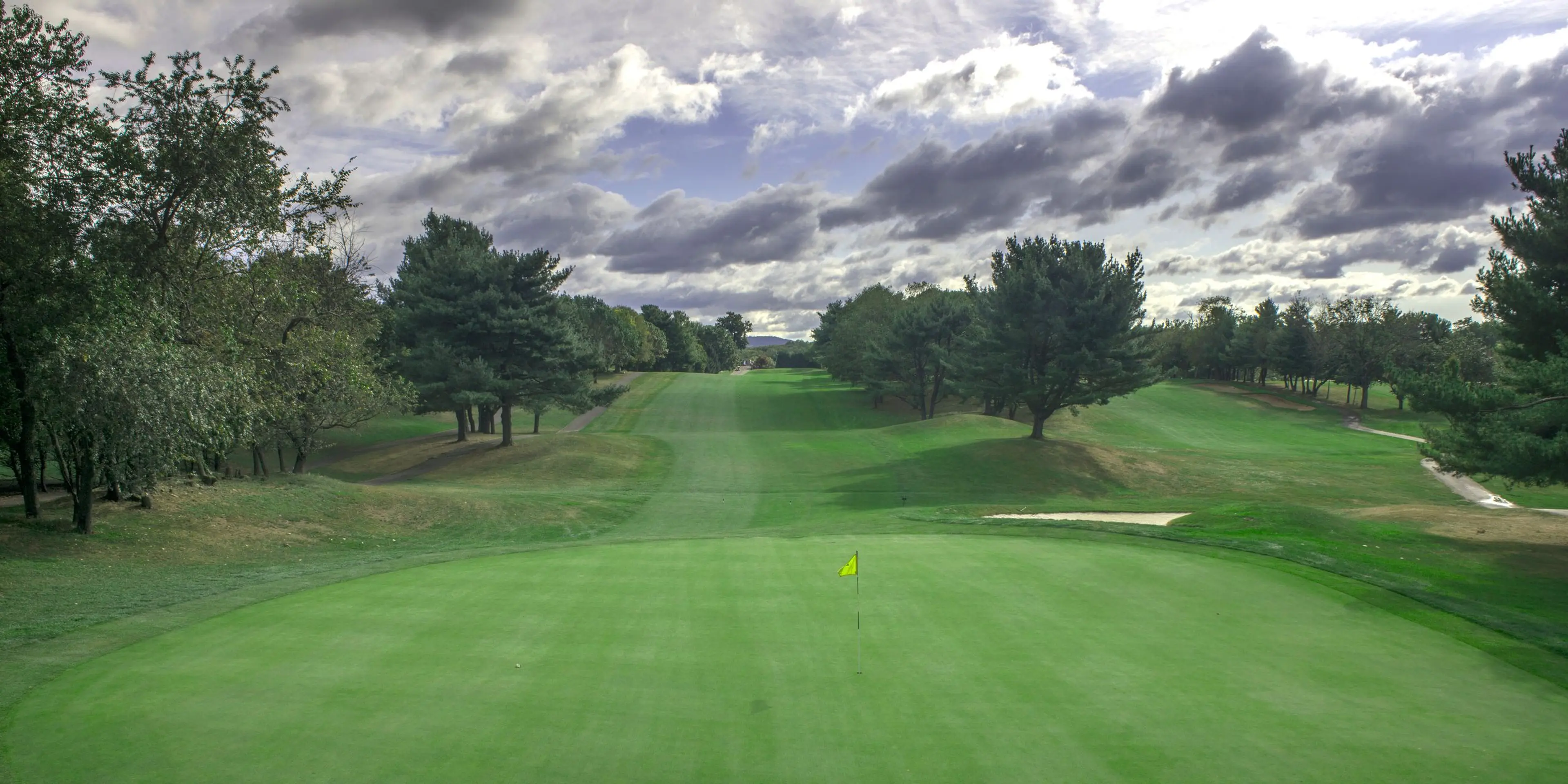 Landscape putting greens and fairway photo of the Blue Hill Golf Course golf course