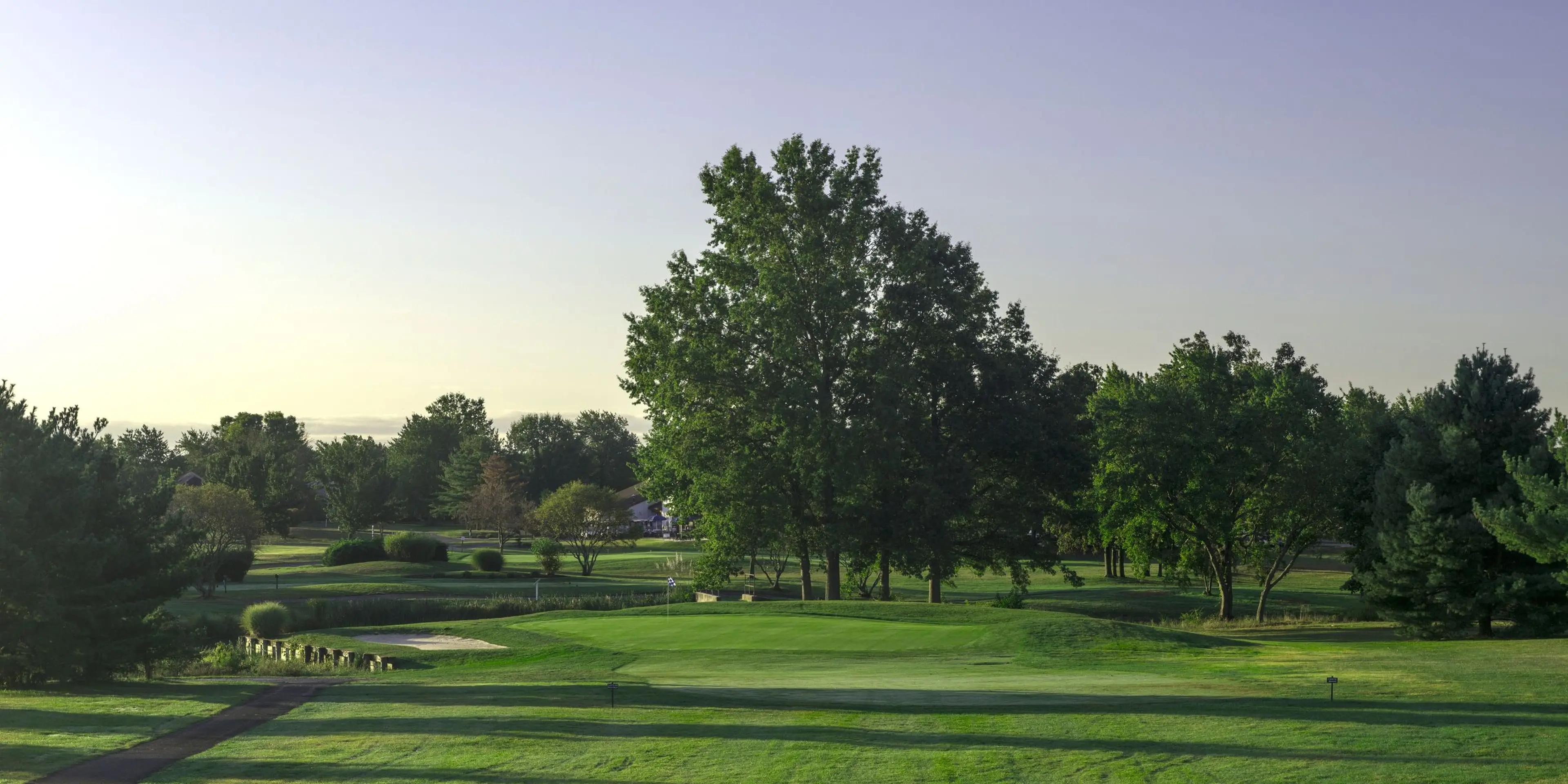 Landscape putting greens and fairway photo of the Concordia Golf Club golf course