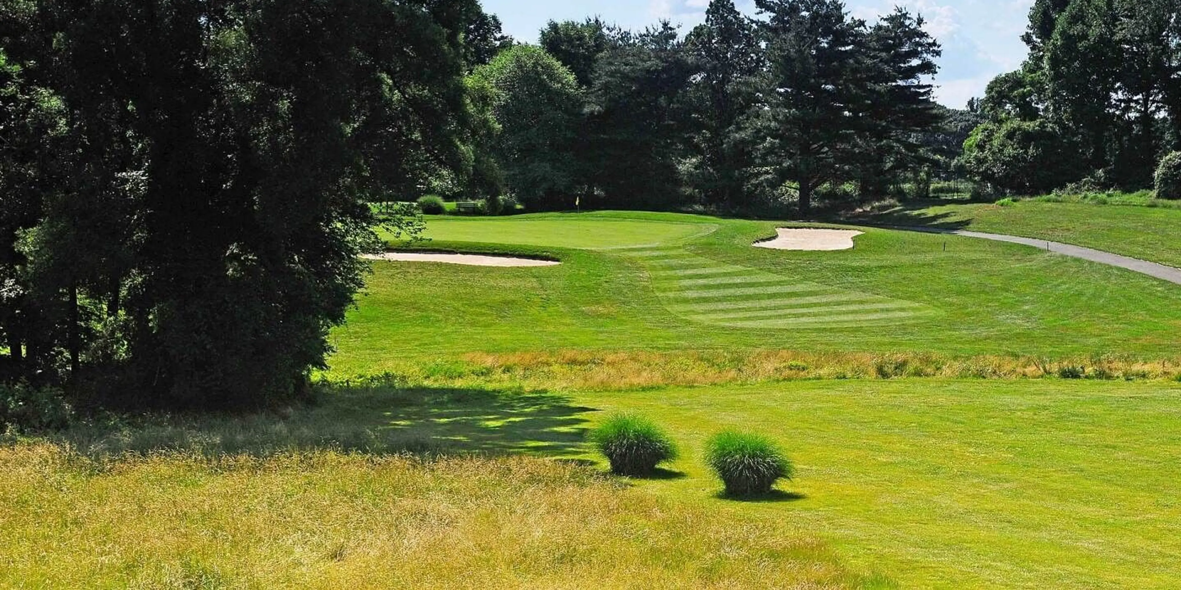 Landscape putting greens and fairway photo of the Delcastle Golf Club golf course