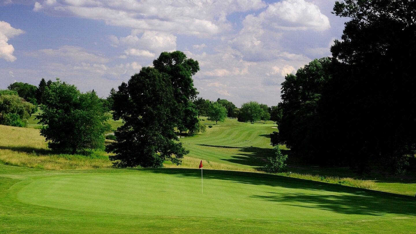 Landscape putting greens and fairway photo of the Delcastle Golf Club golf course
