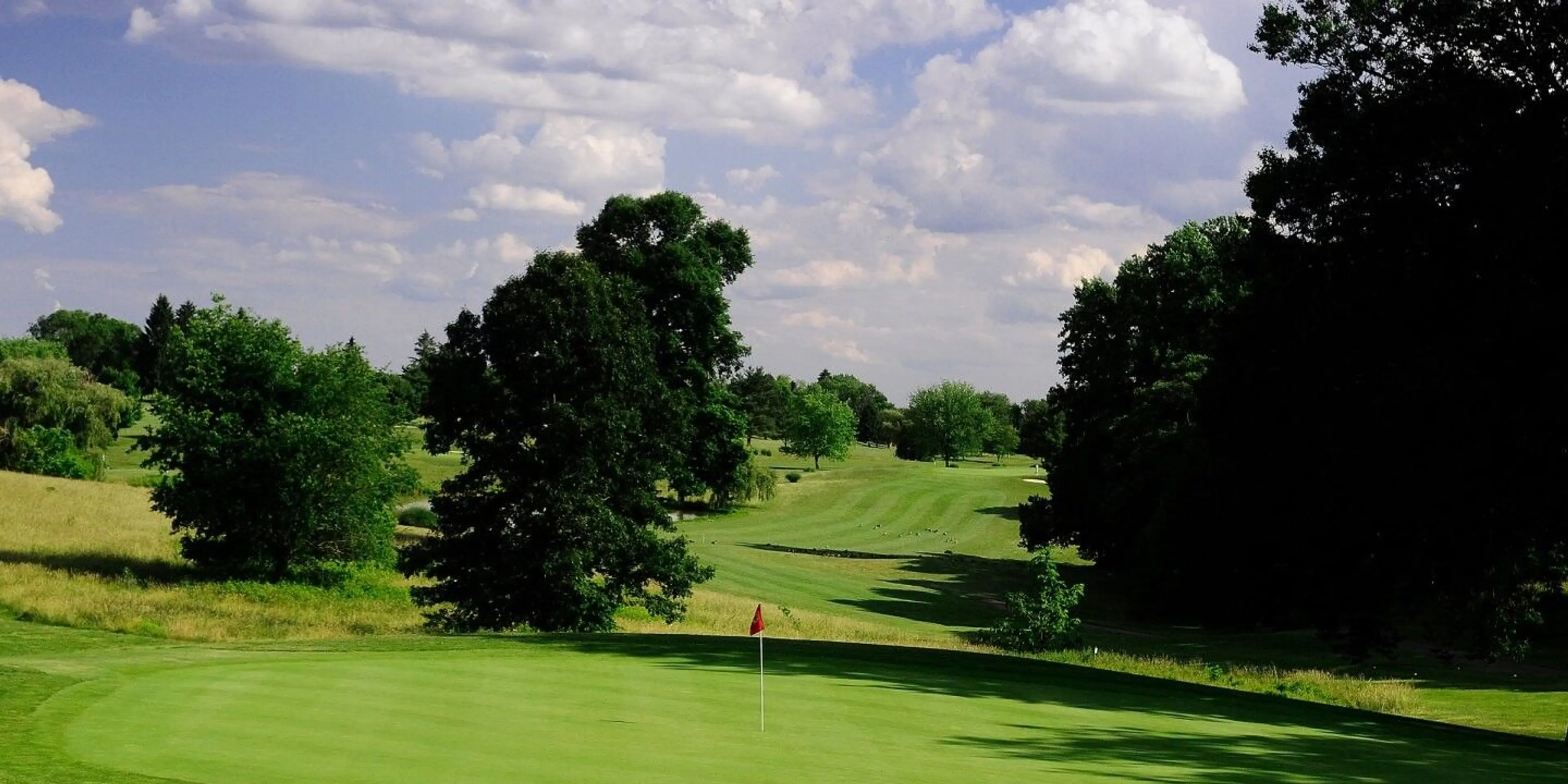 Landscape putting greens and fairway photo of the Delcastle Golf Club golf course