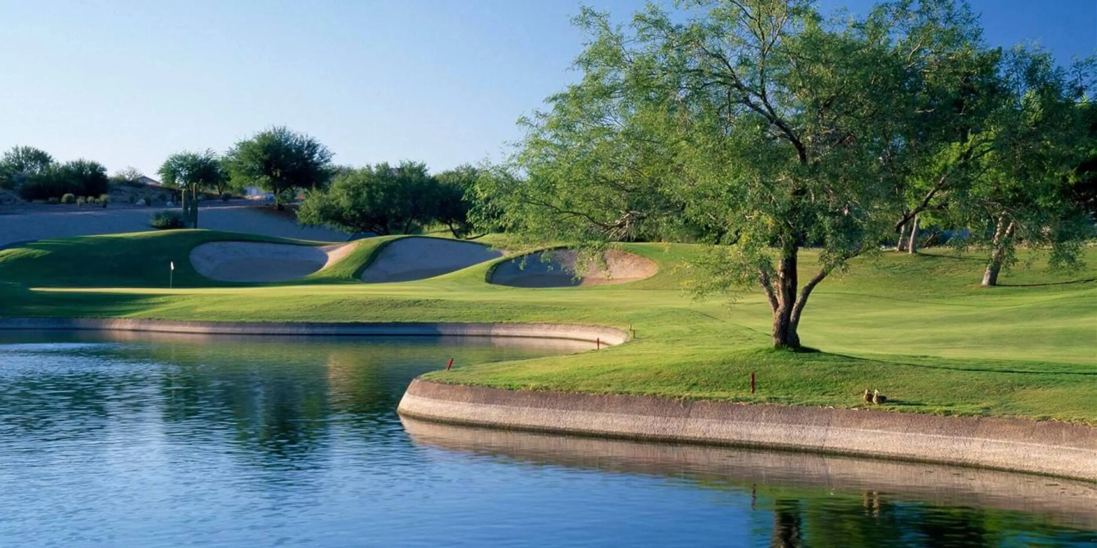 Landscape putting greens and fairway photo of the El Conquistador Golf Club golf course