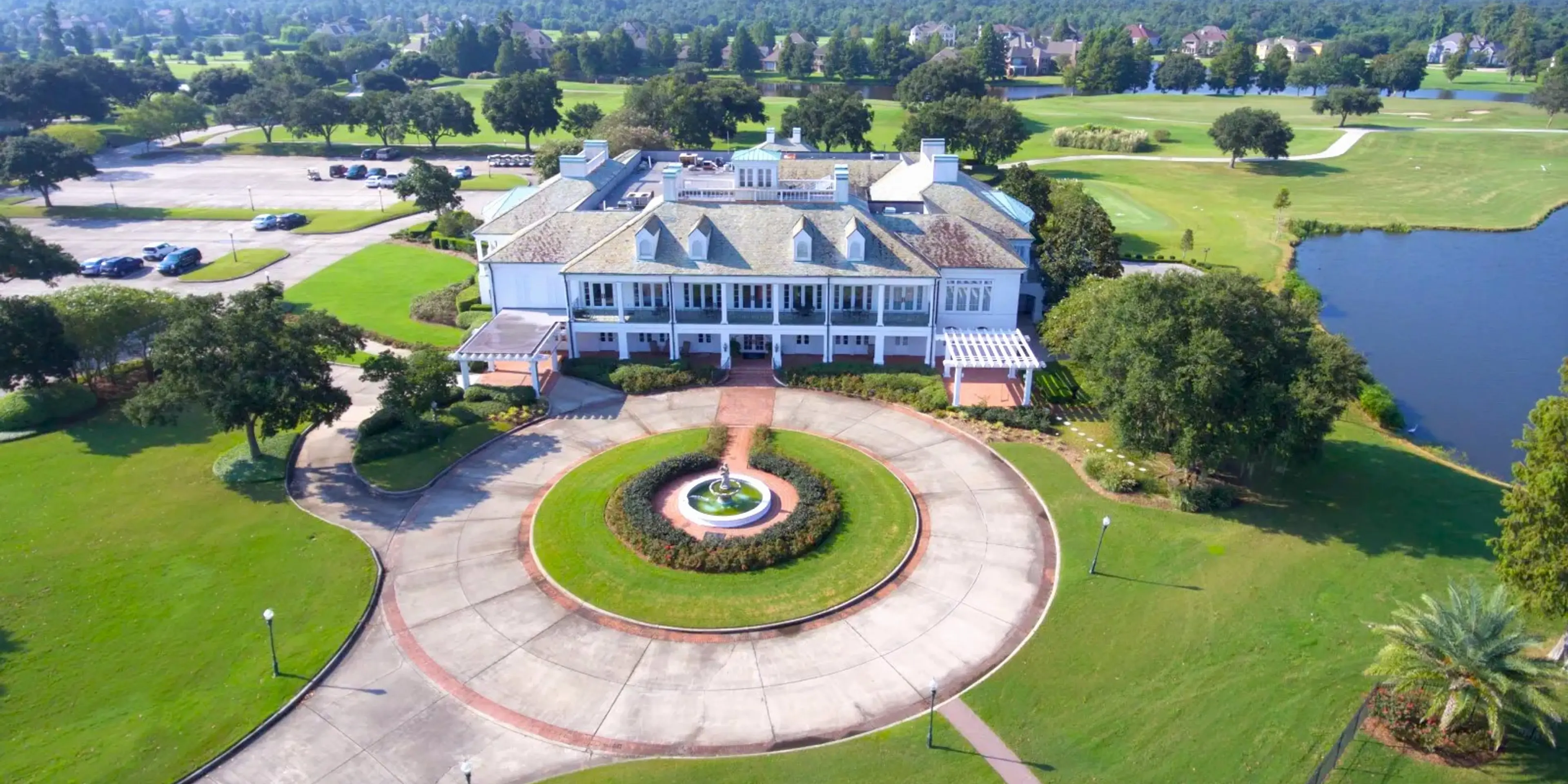 Landscape putting greens and fairway photo of the English Turn Golf & Country Club golf course