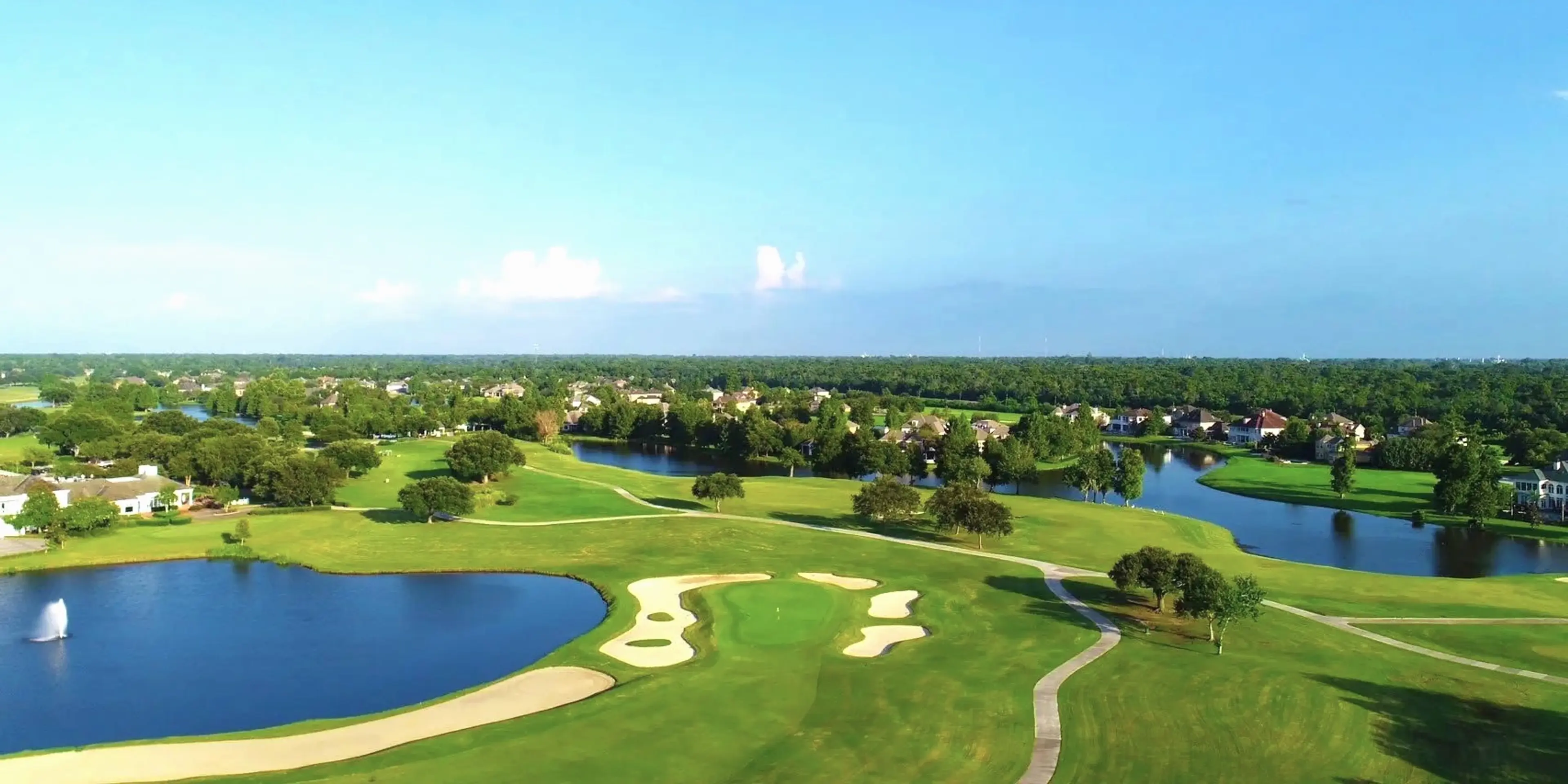 Landscape putting greens and fairway photo of the English Turn Golf & Country Club golf course