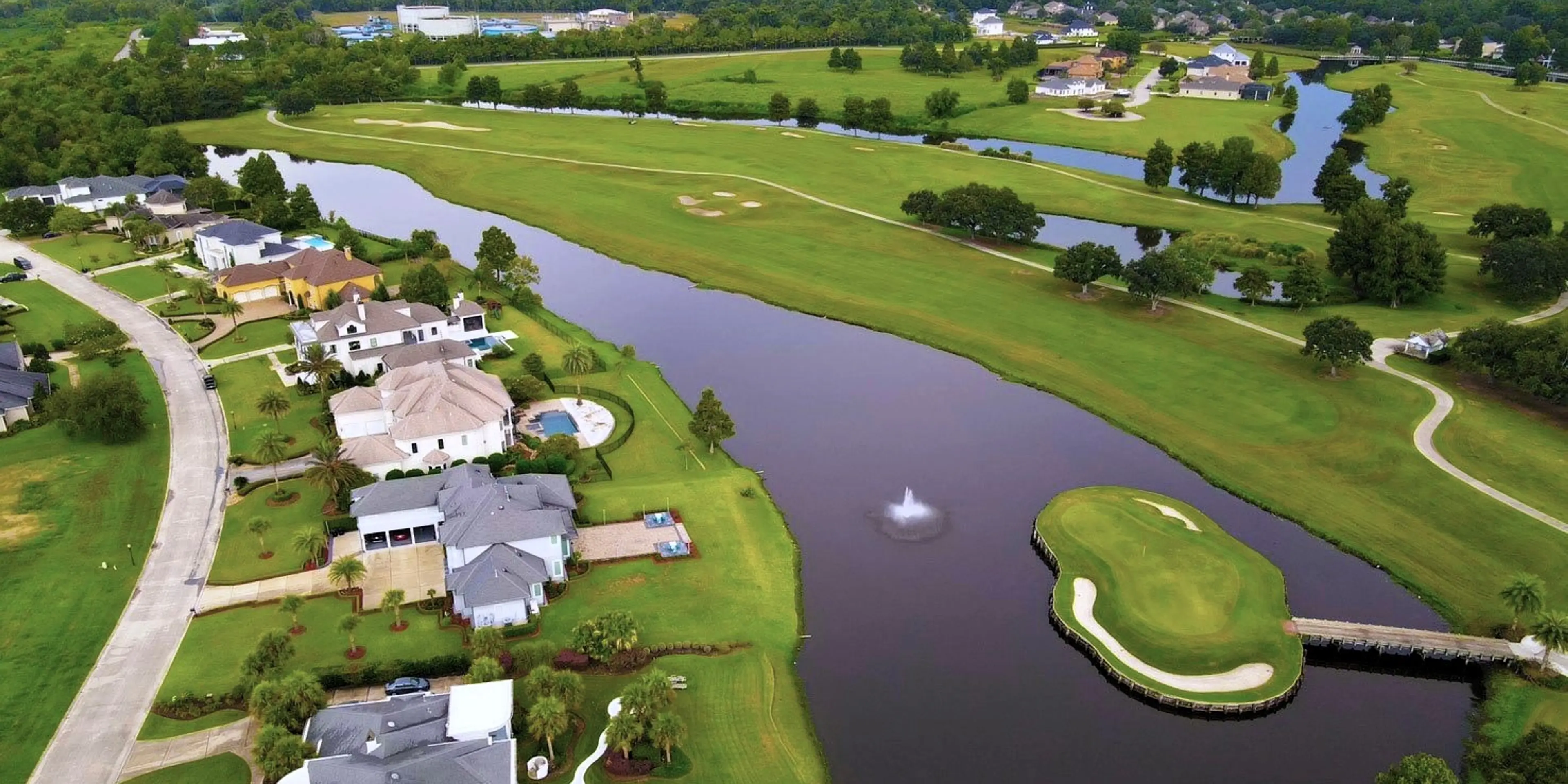 Landscape putting greens and fairway photo of the English Turn Golf & Country Club golf course