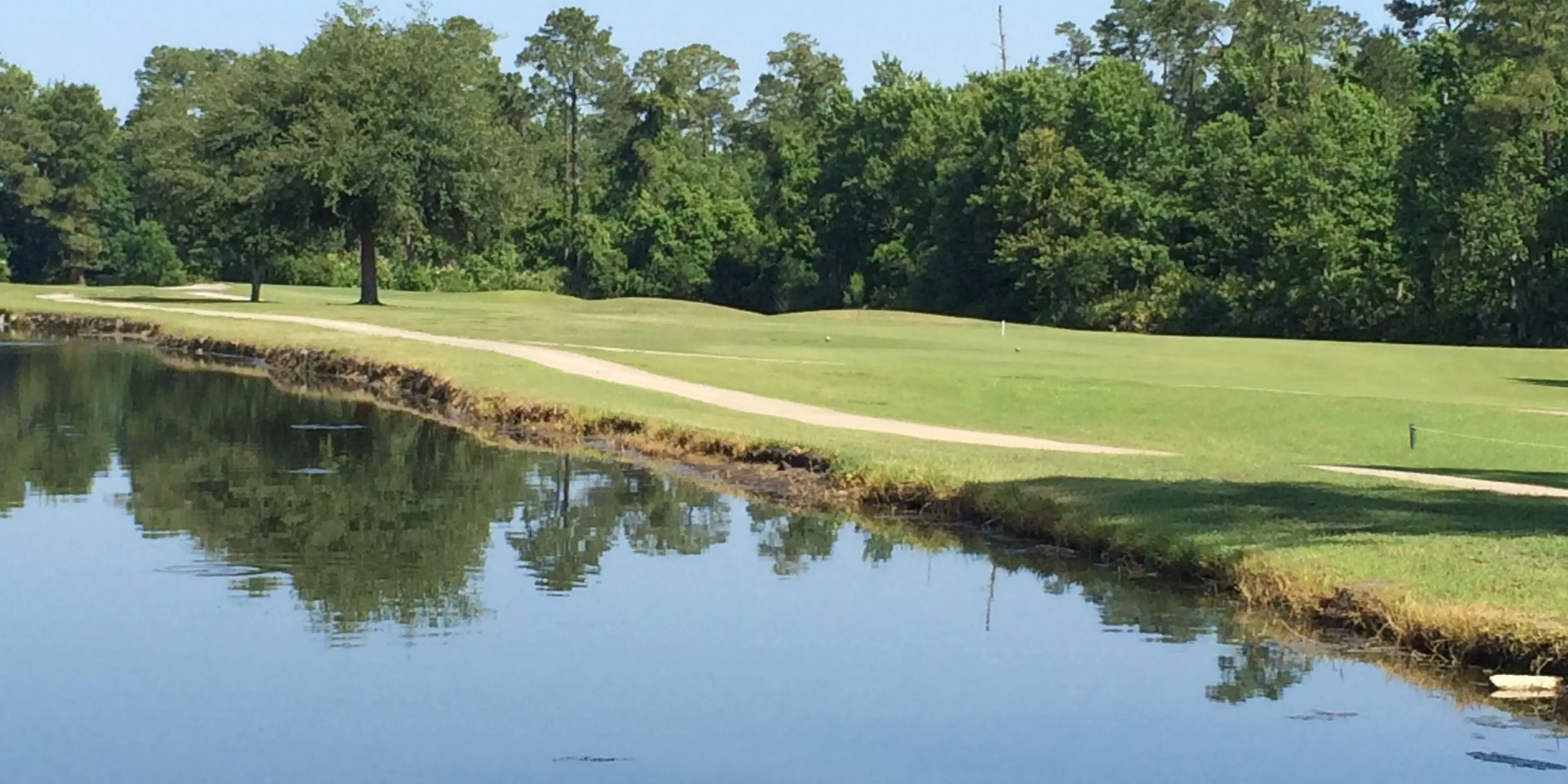 Landscape putting greens and fairway photo of the Fairways Country Club golf course