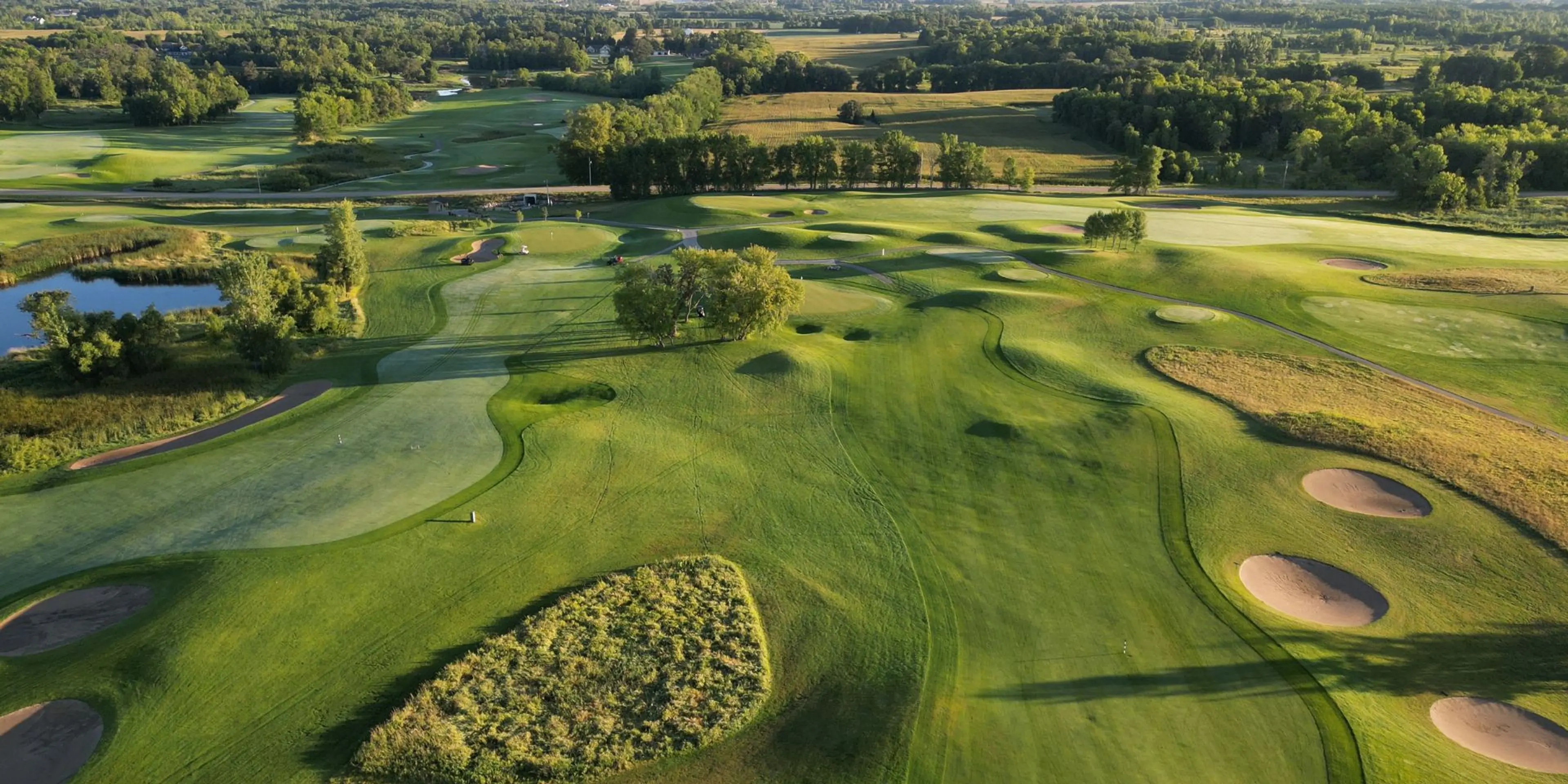 Landscape putting greens and fairway photo of the Geneva Golf Club golf course