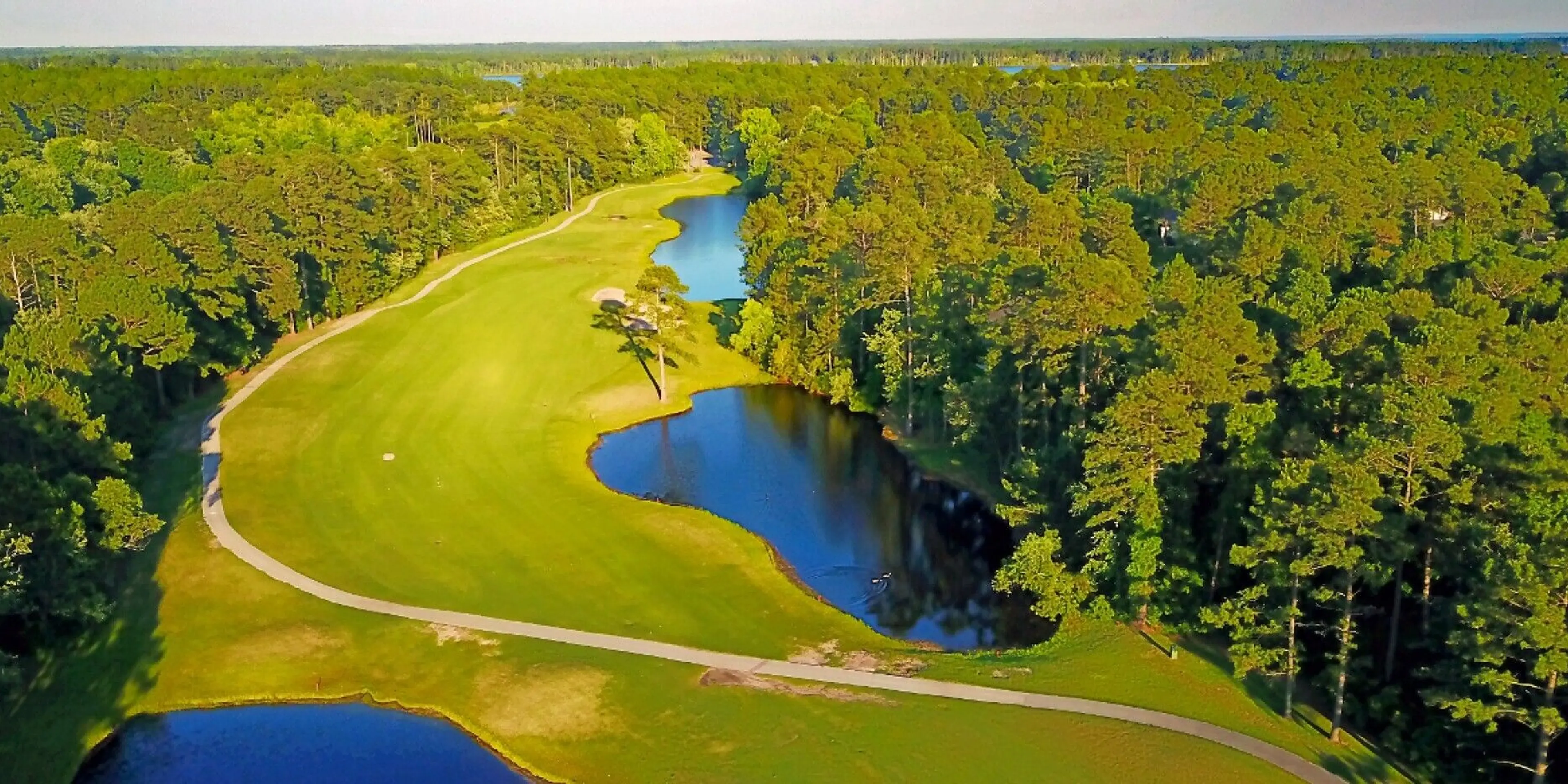 Landscape putting greens and fairway photo of the Harbour Pointe Golf Club golf course