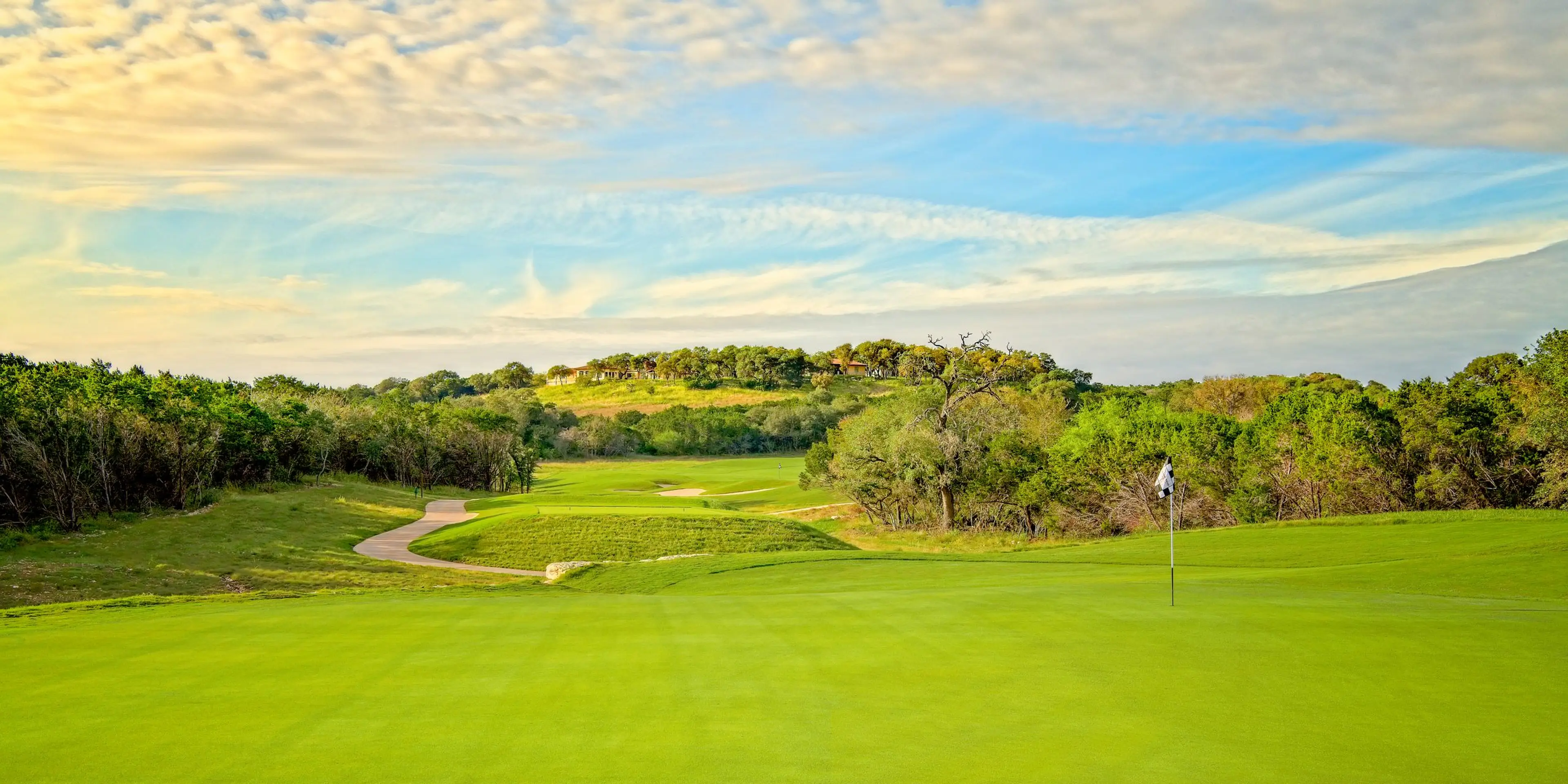 Landscape putting greens and fairway photo of the Kissing Tree Golf Club golf course