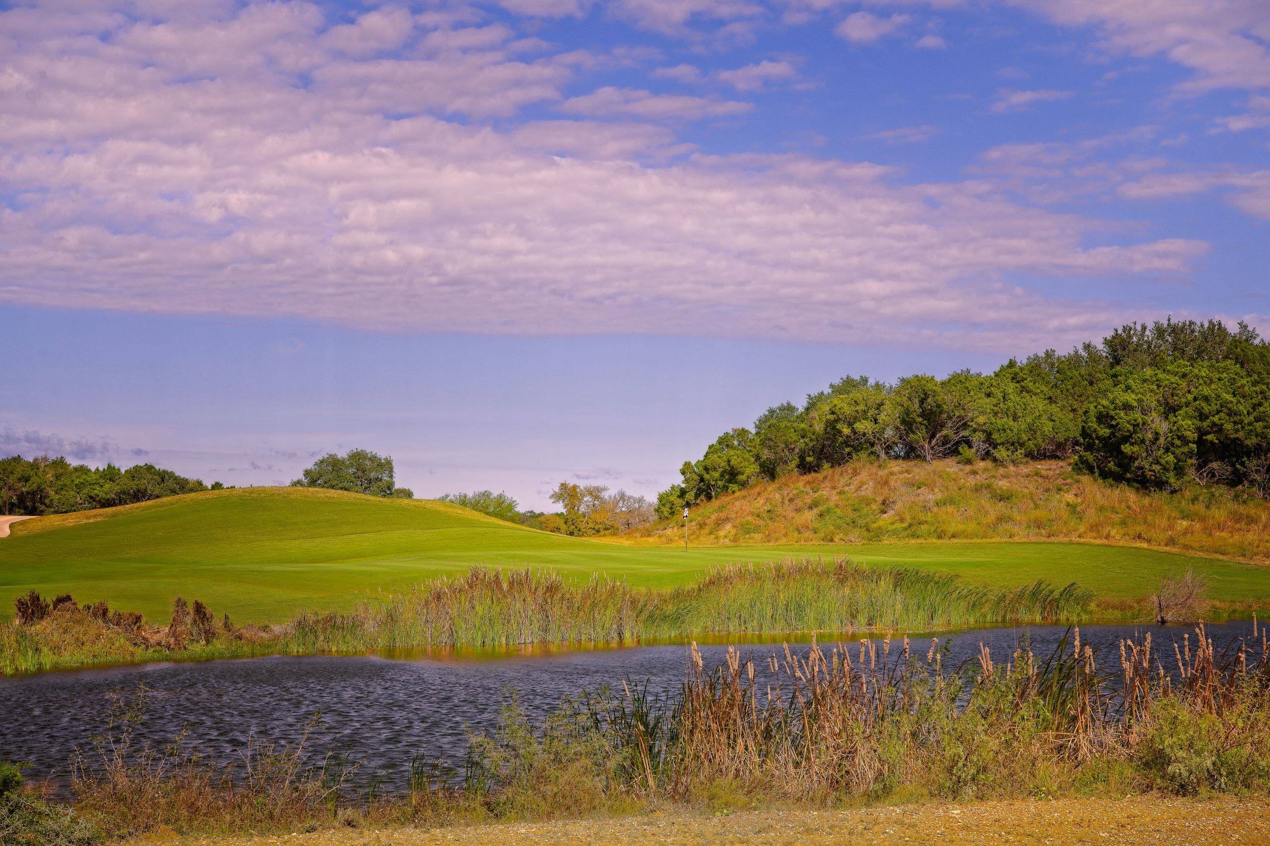 Landscape putting greens and fairway photo of the Kissing Tree Golf Club golf course
