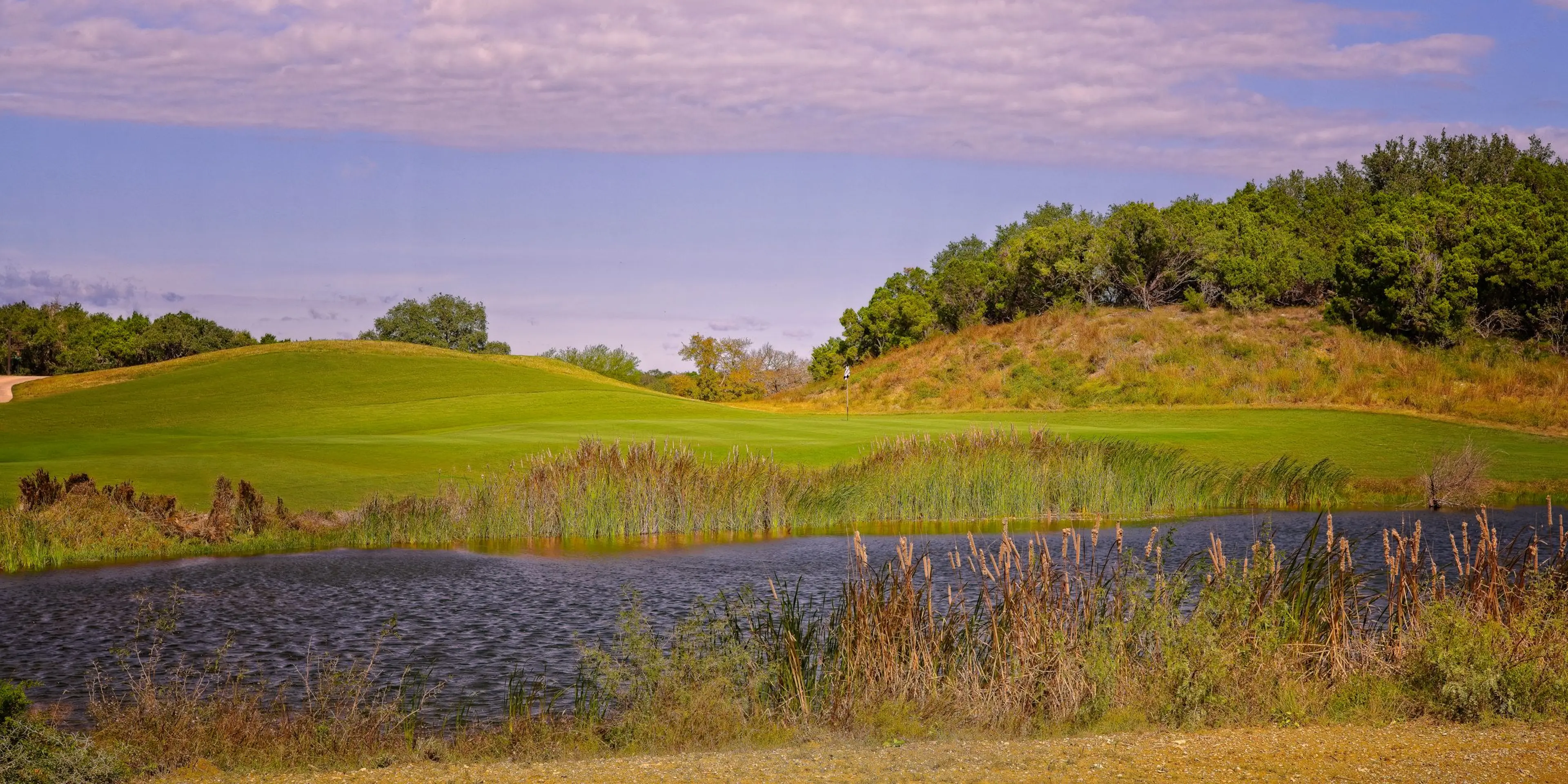 Landscape putting greens and fairway photo of the Kissing Tree Golf Club golf course