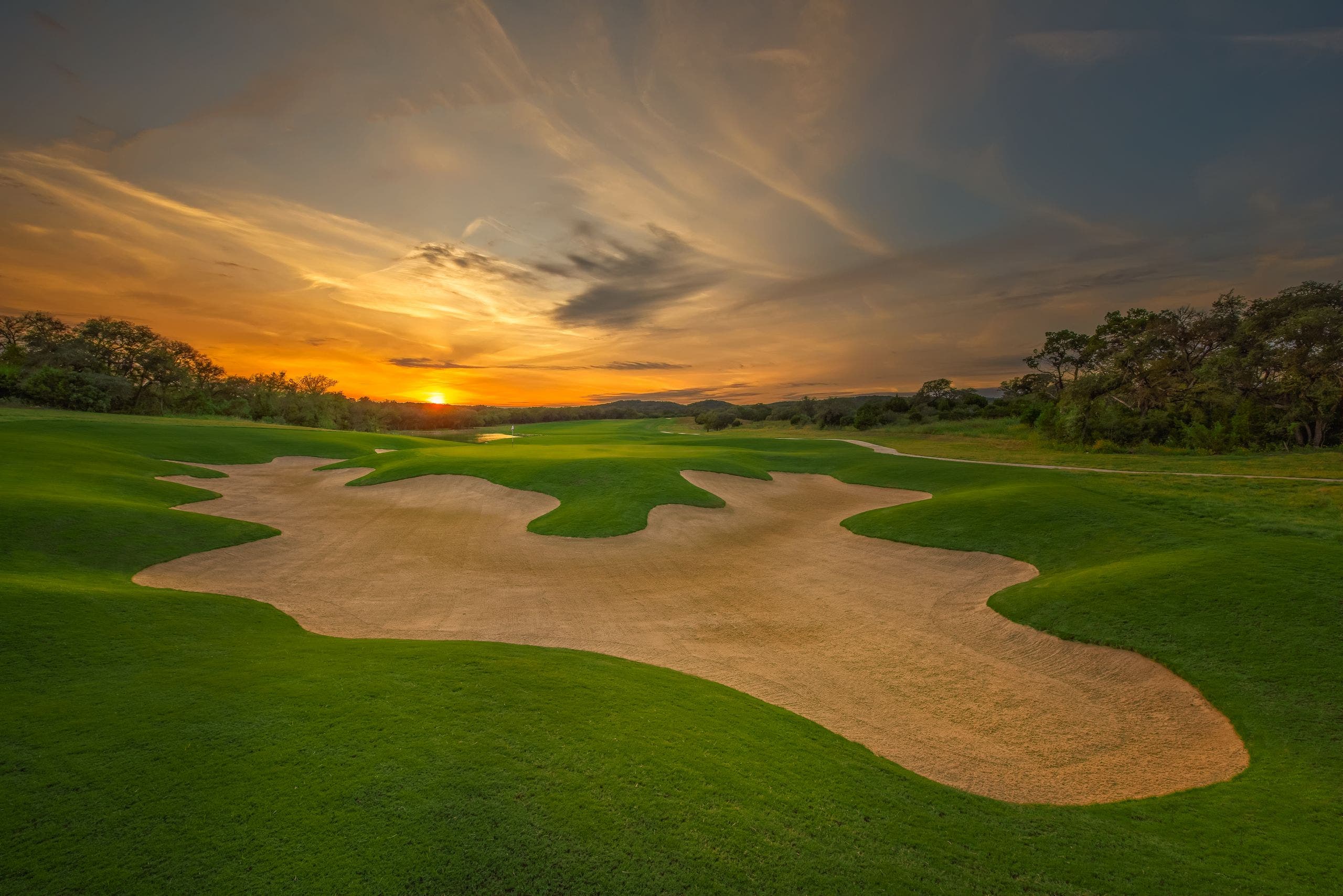 Landscape putting greens and fairway photo of the Kissing Tree Golf Club golf course