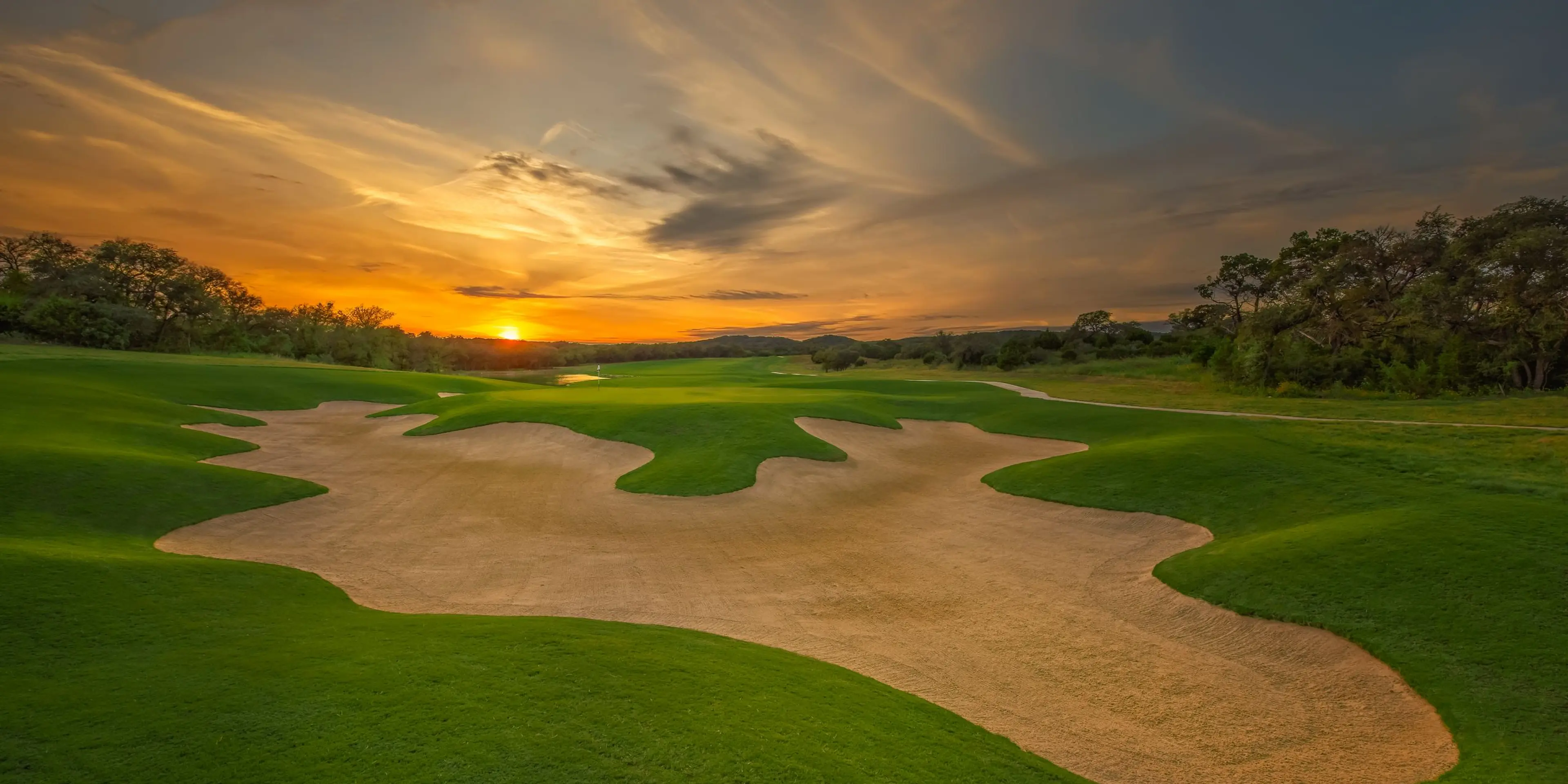 Landscape putting greens and fairway photo of the Kissing Tree Golf Club golf course
