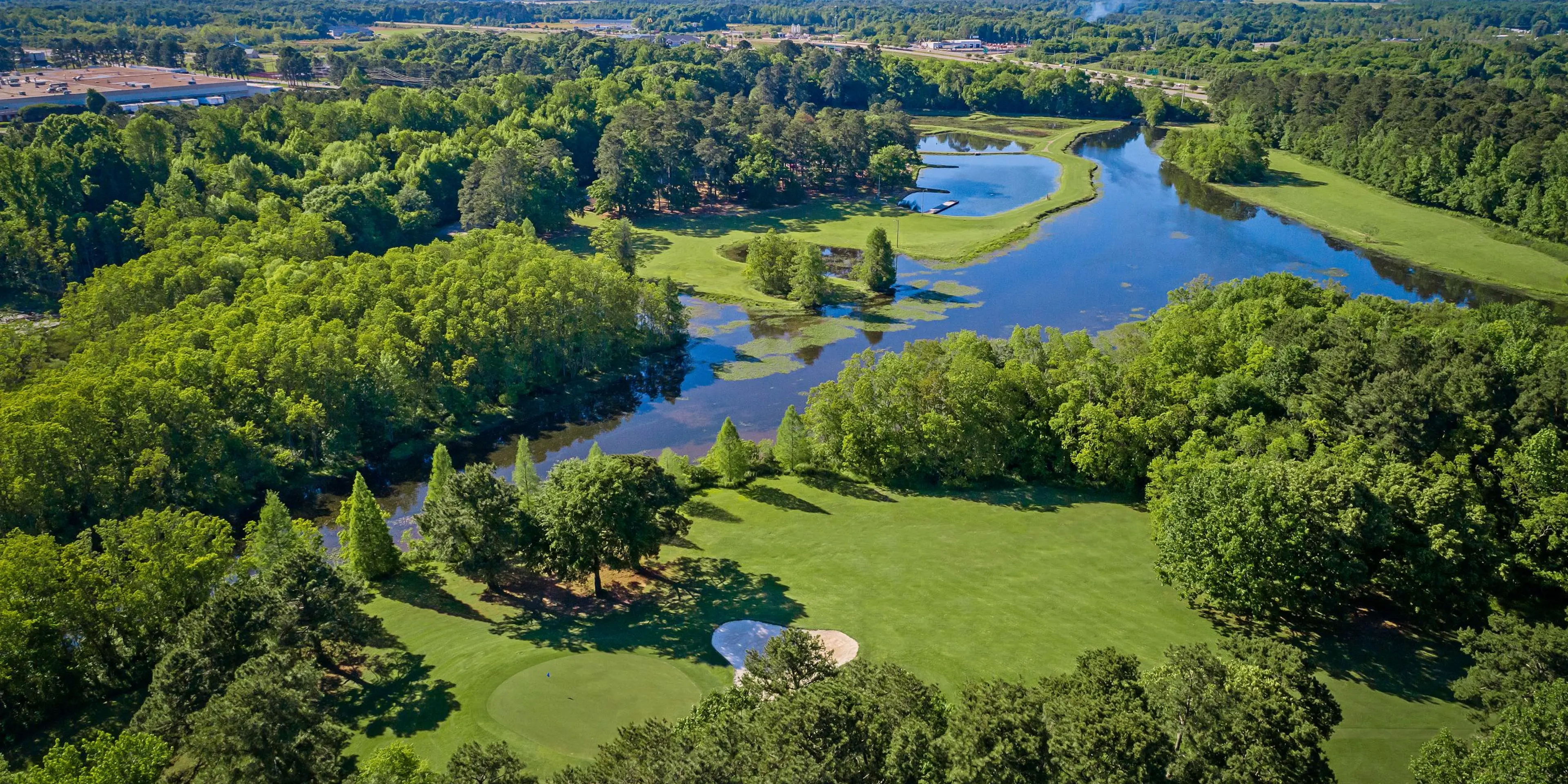 Landscape putting greens and fairway photo of the Lagoon Park Golf Course golf course