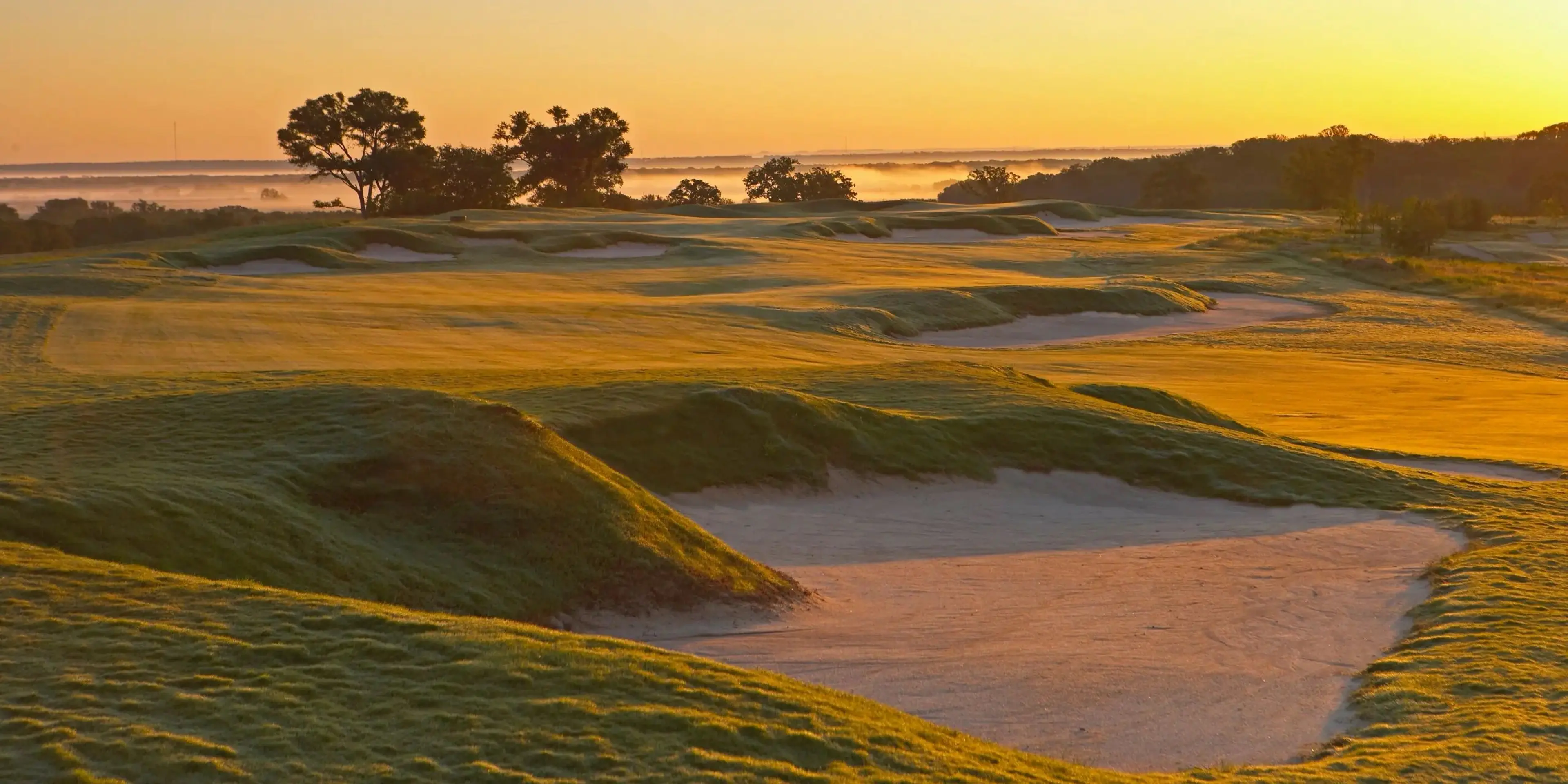 Landscape putting greens and fairway photo of the Lost Pines Golf Club golf course