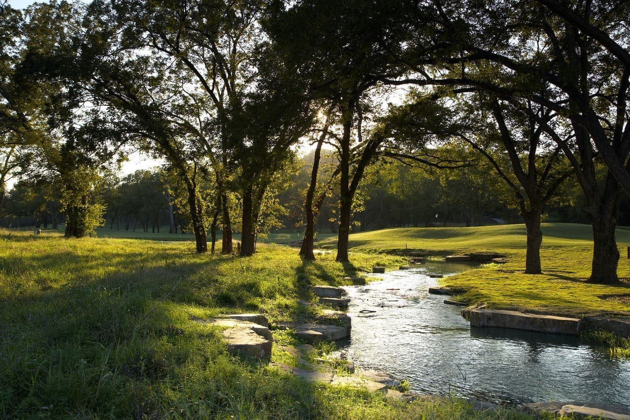 Landscape putting greens and fairway photo of the Lost Pines Golf Club golf course