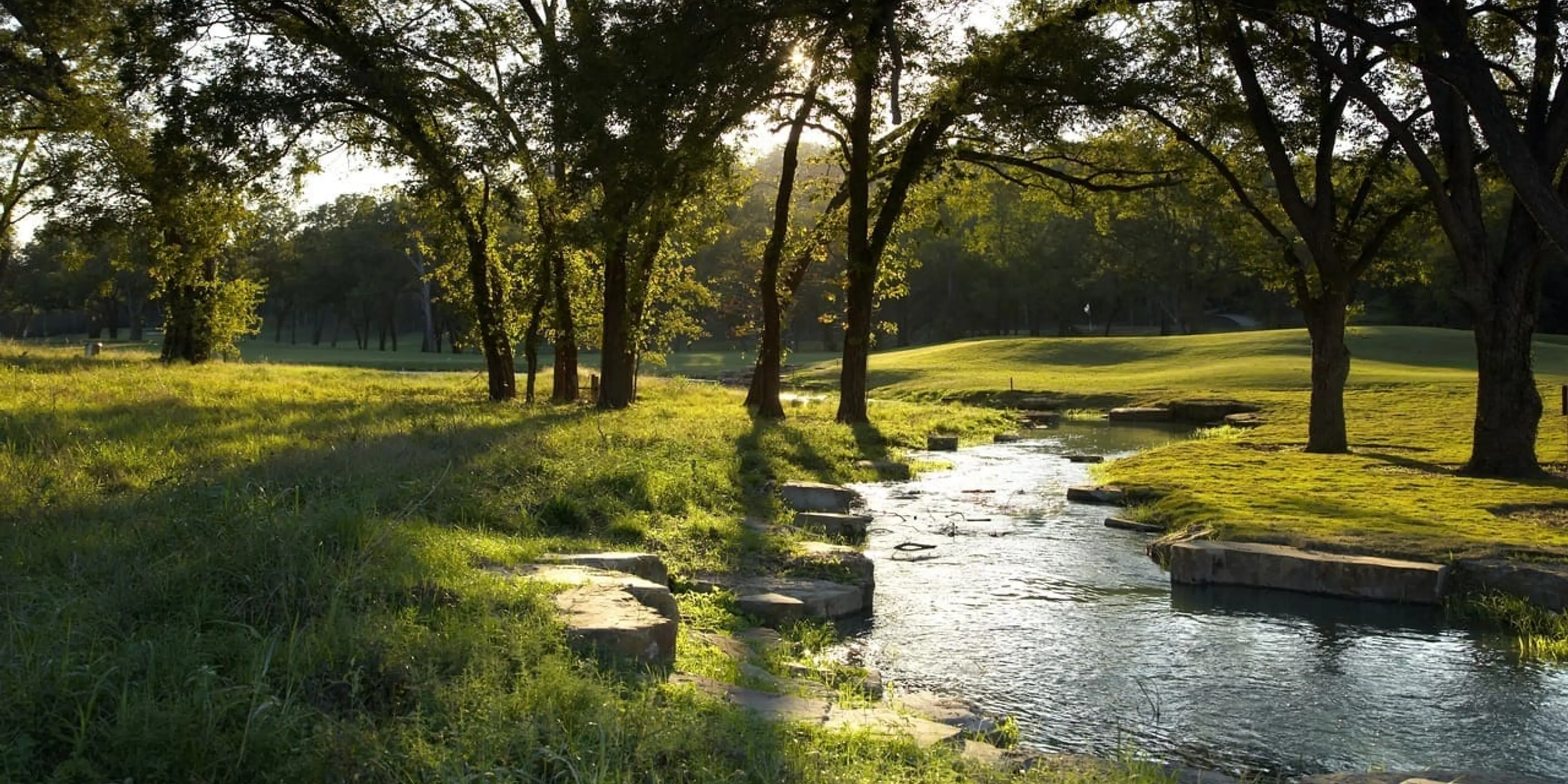 Landscape putting greens and fairway photo of the Lost Pines Golf Club golf course