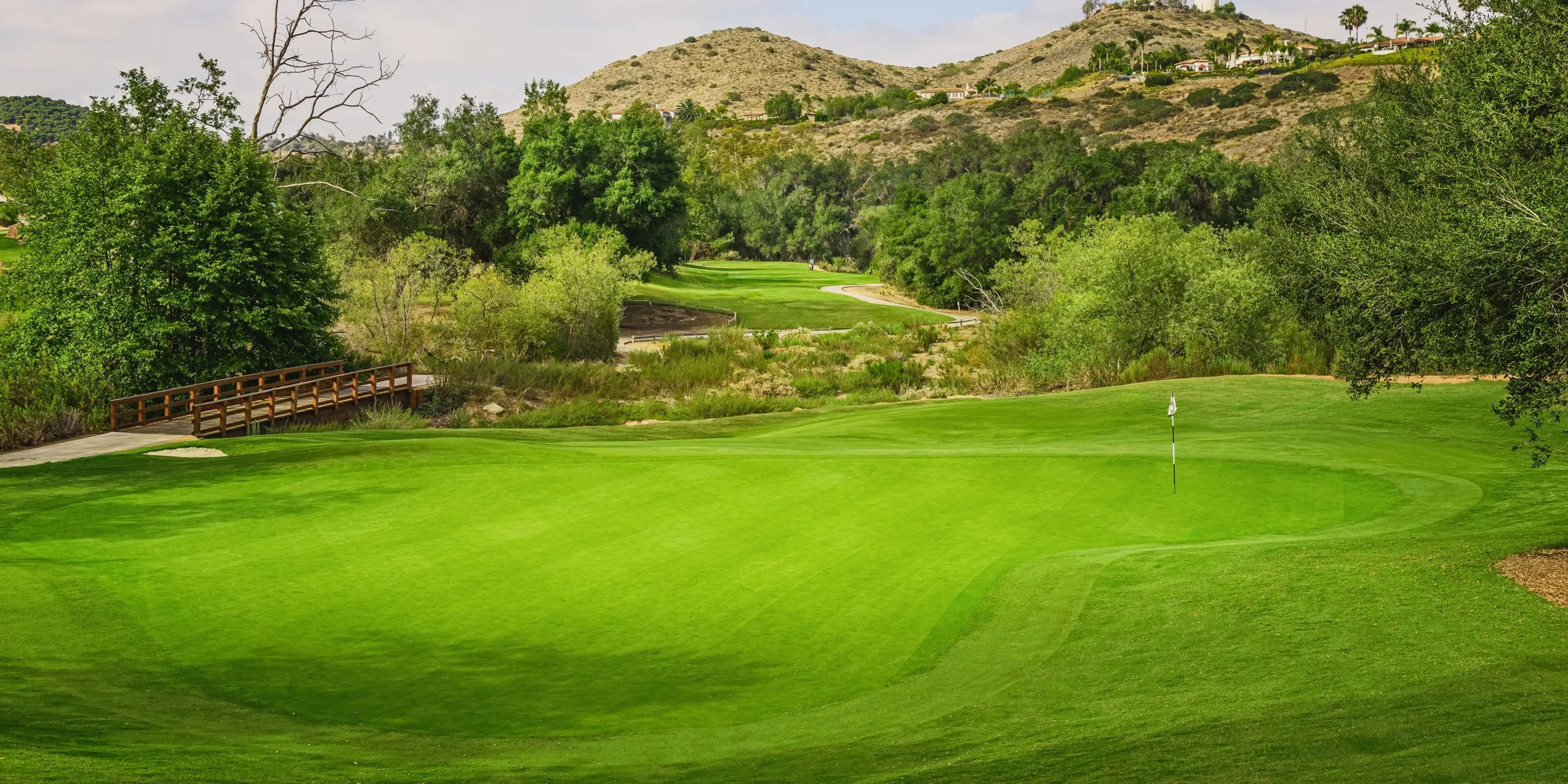 Landscape putting greens and fairway photo of the Maderas Golf Club golf course
