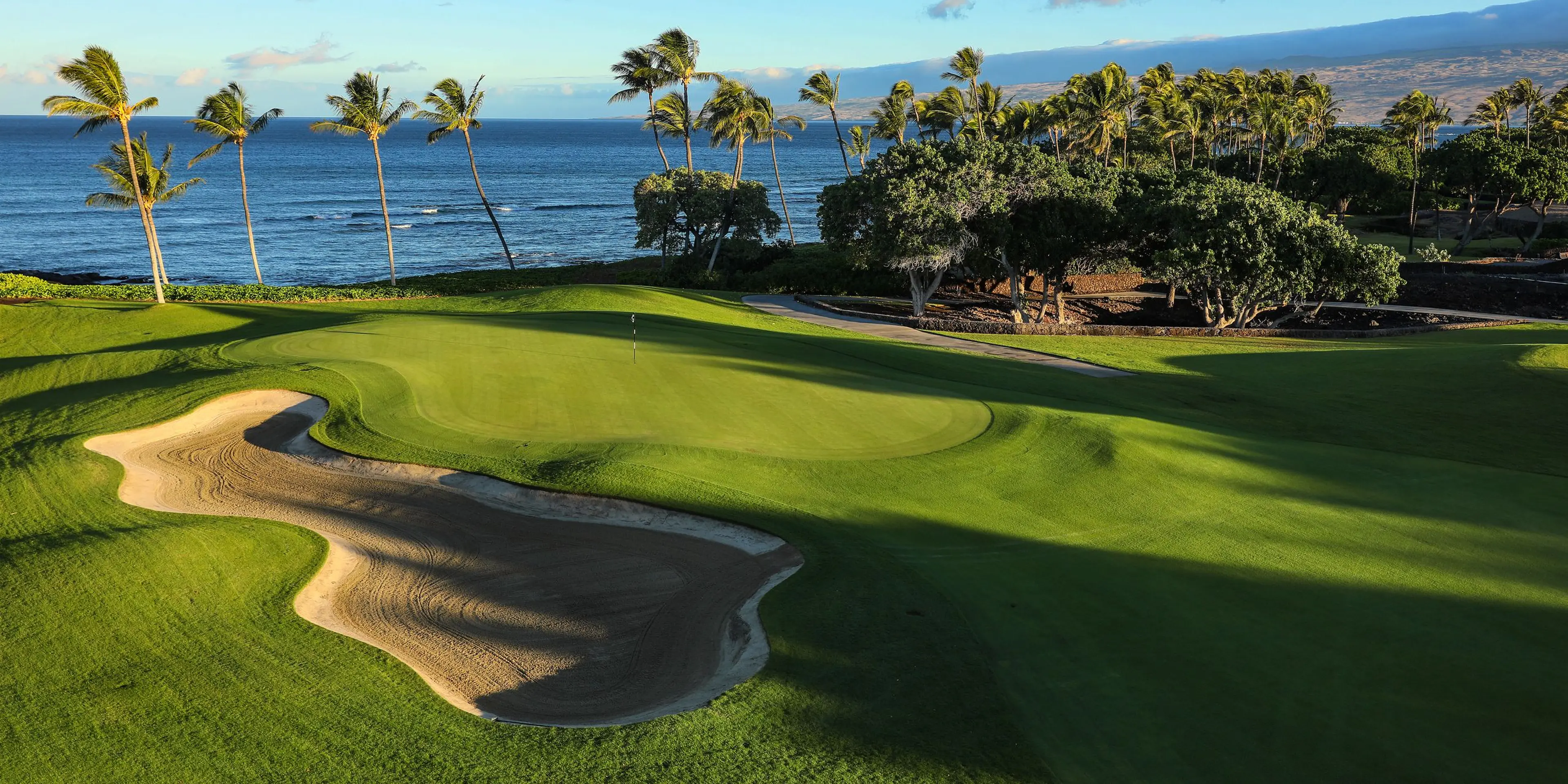 Landscape putting greens and fairway photo of the Mauna Lani Auberge Collection golf course