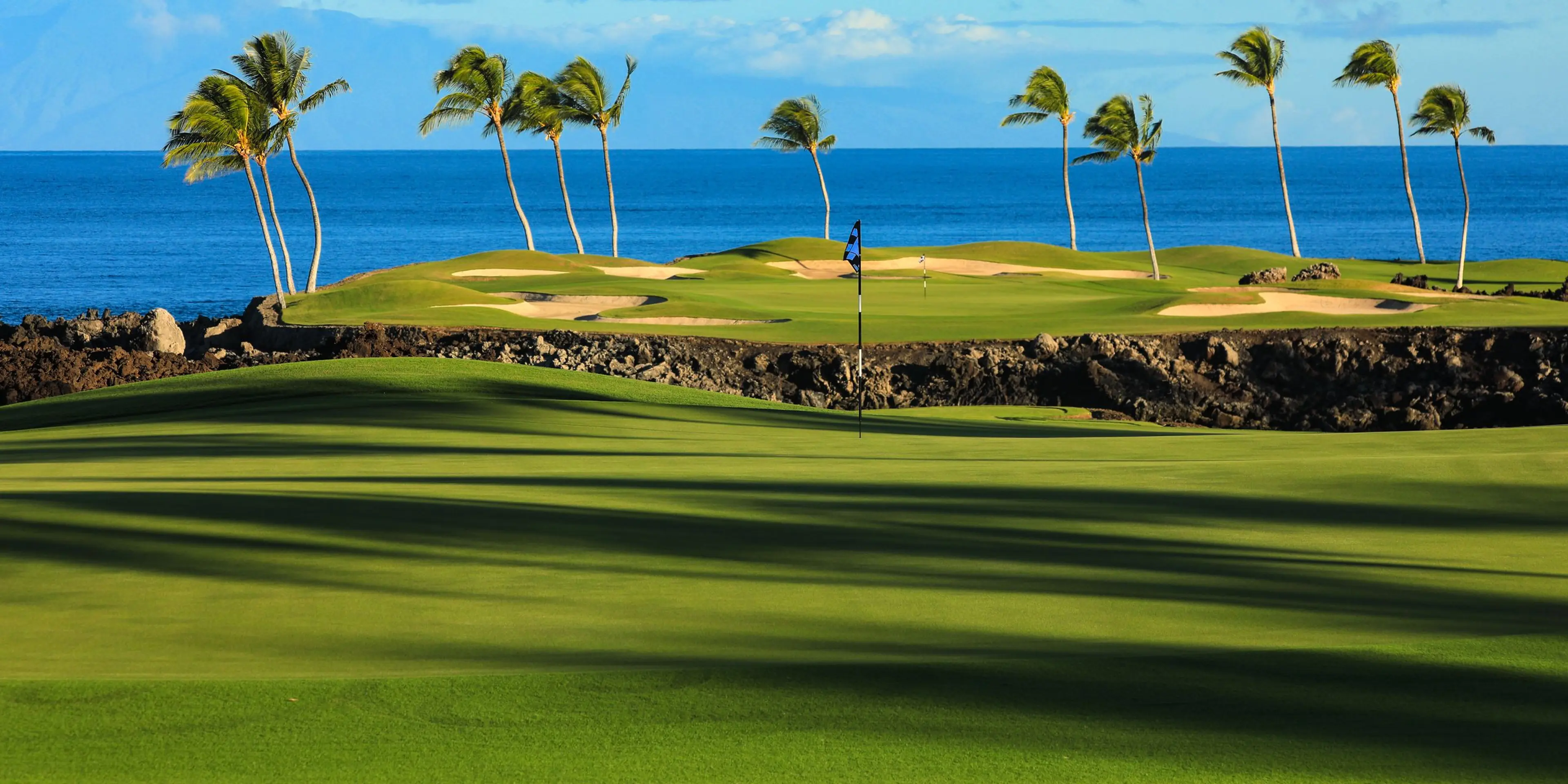 Landscape putting greens and fairway photo of the Mauna Lani Auberge Collection golf course