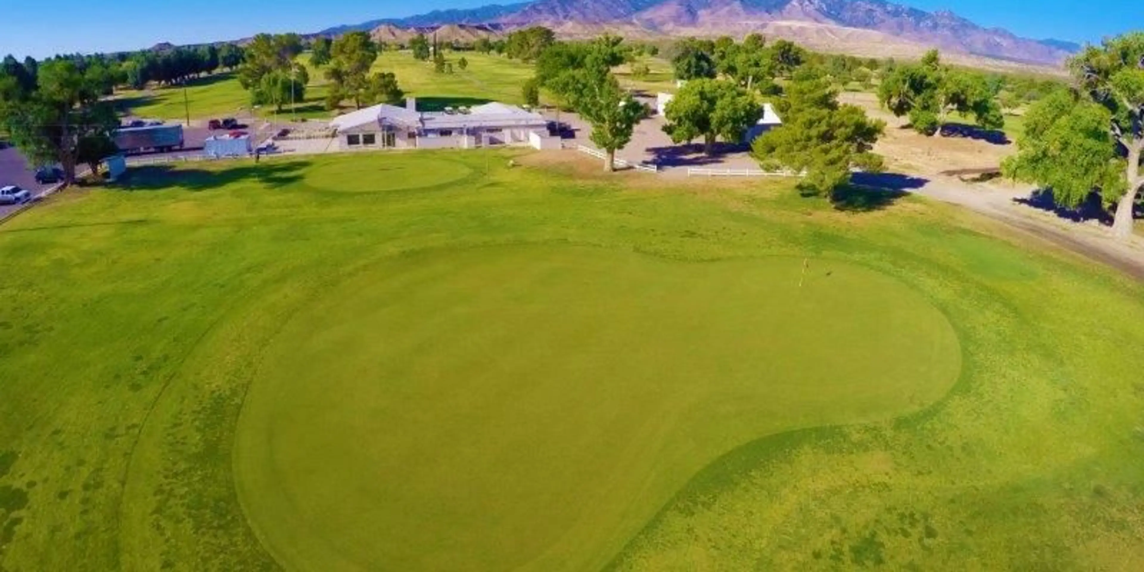 Landscape putting greens and fairway photo of the Mt Graham Golf Club golf course
