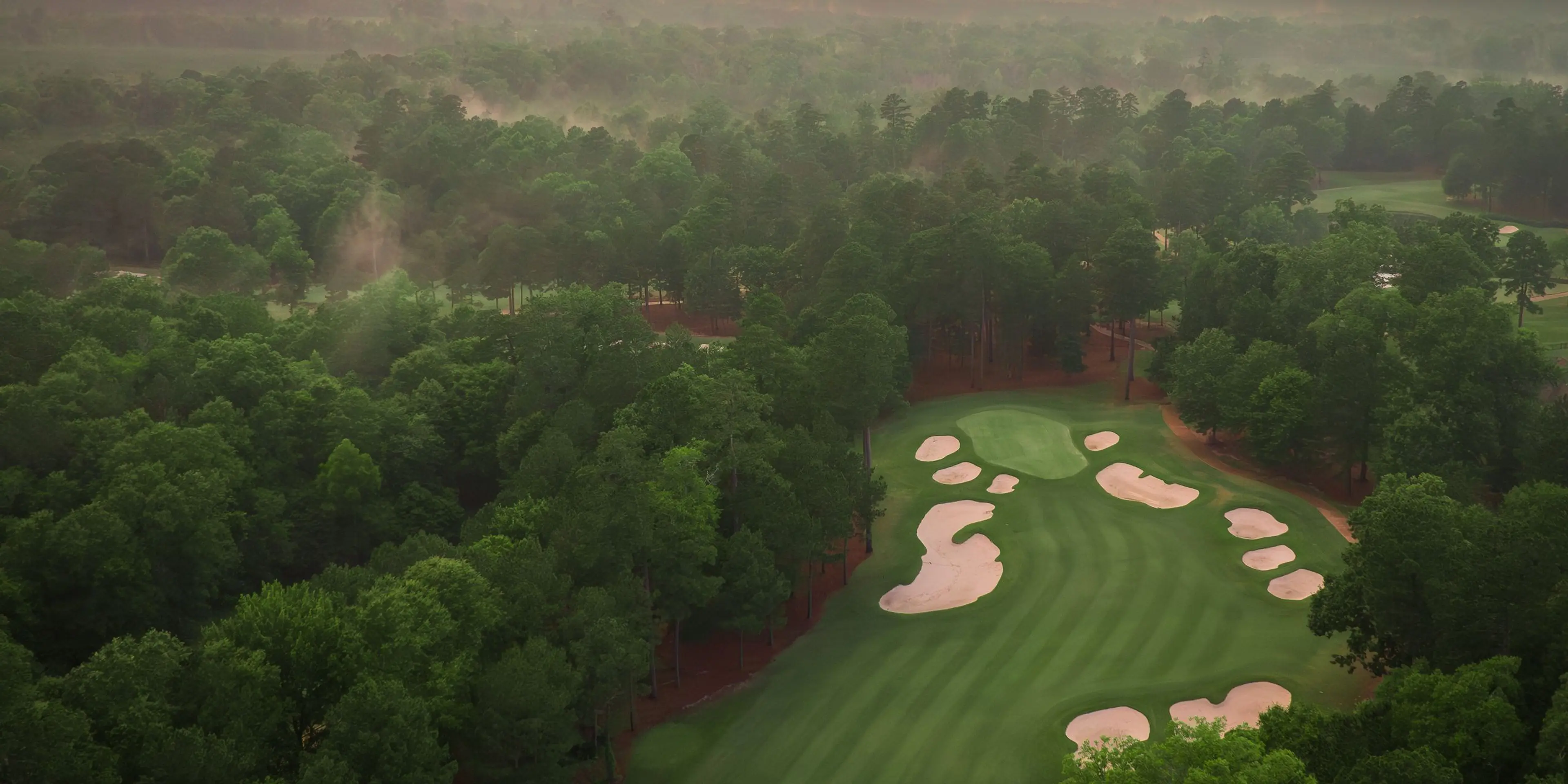 Landscape putting greens and fairway photo of the Mystic Creek Golf Club golf course
