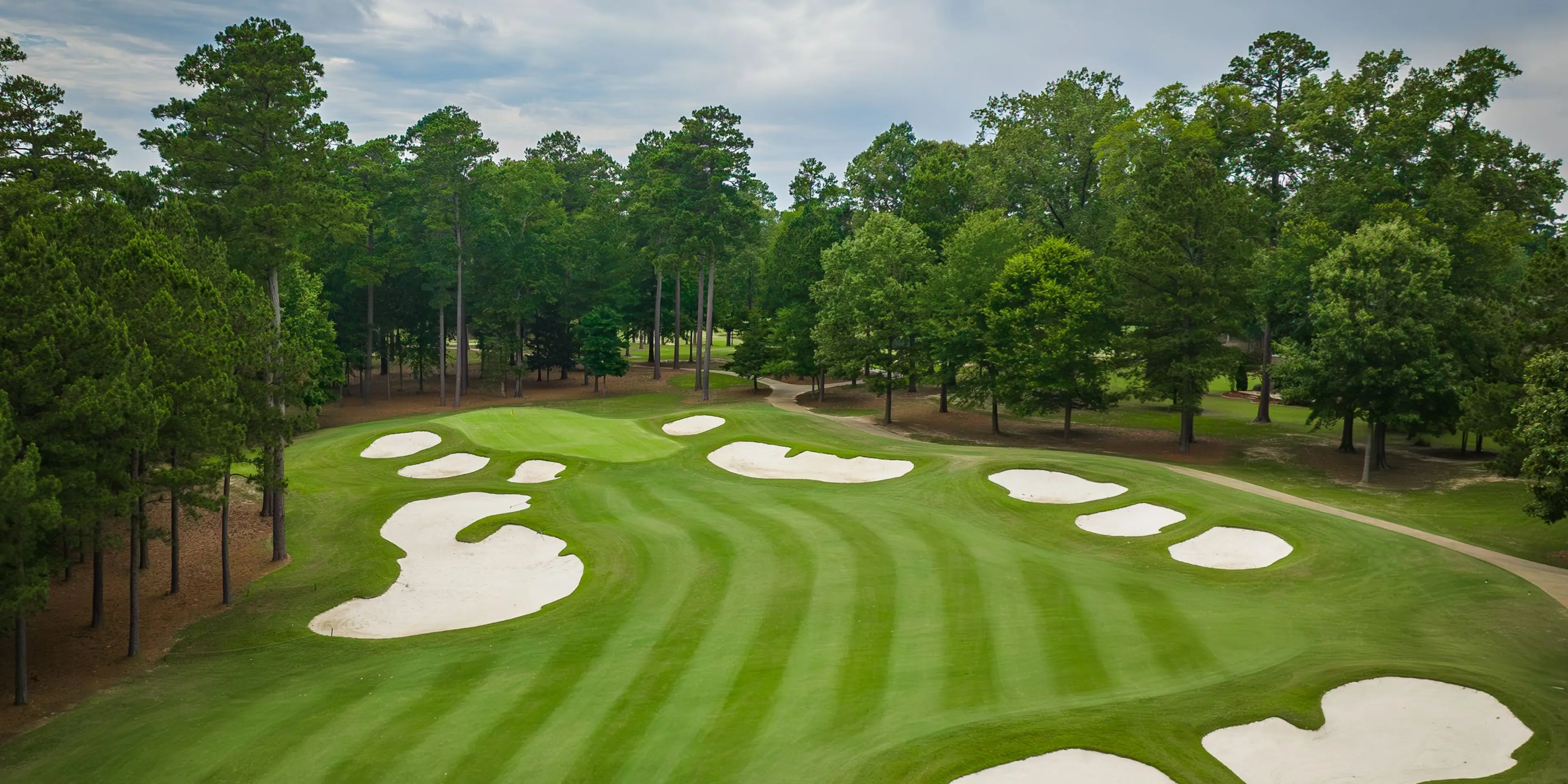 Landscape putting greens and fairway photo of the Mystic Creek Golf Club golf course