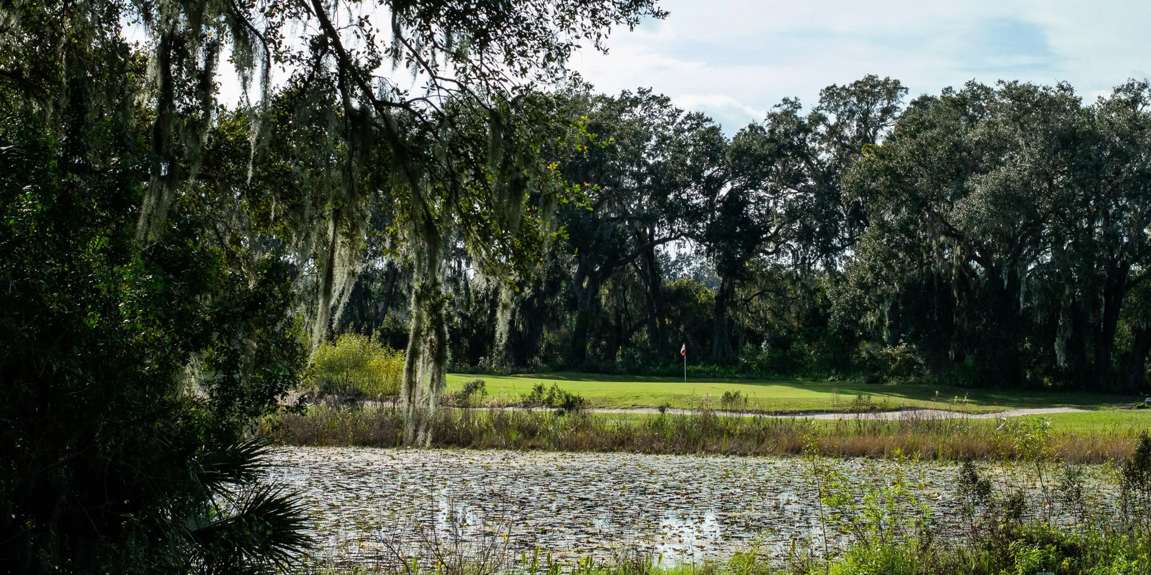 Landscape putting greens and fairway photo of the Mystic Dunes Golf Club golf course