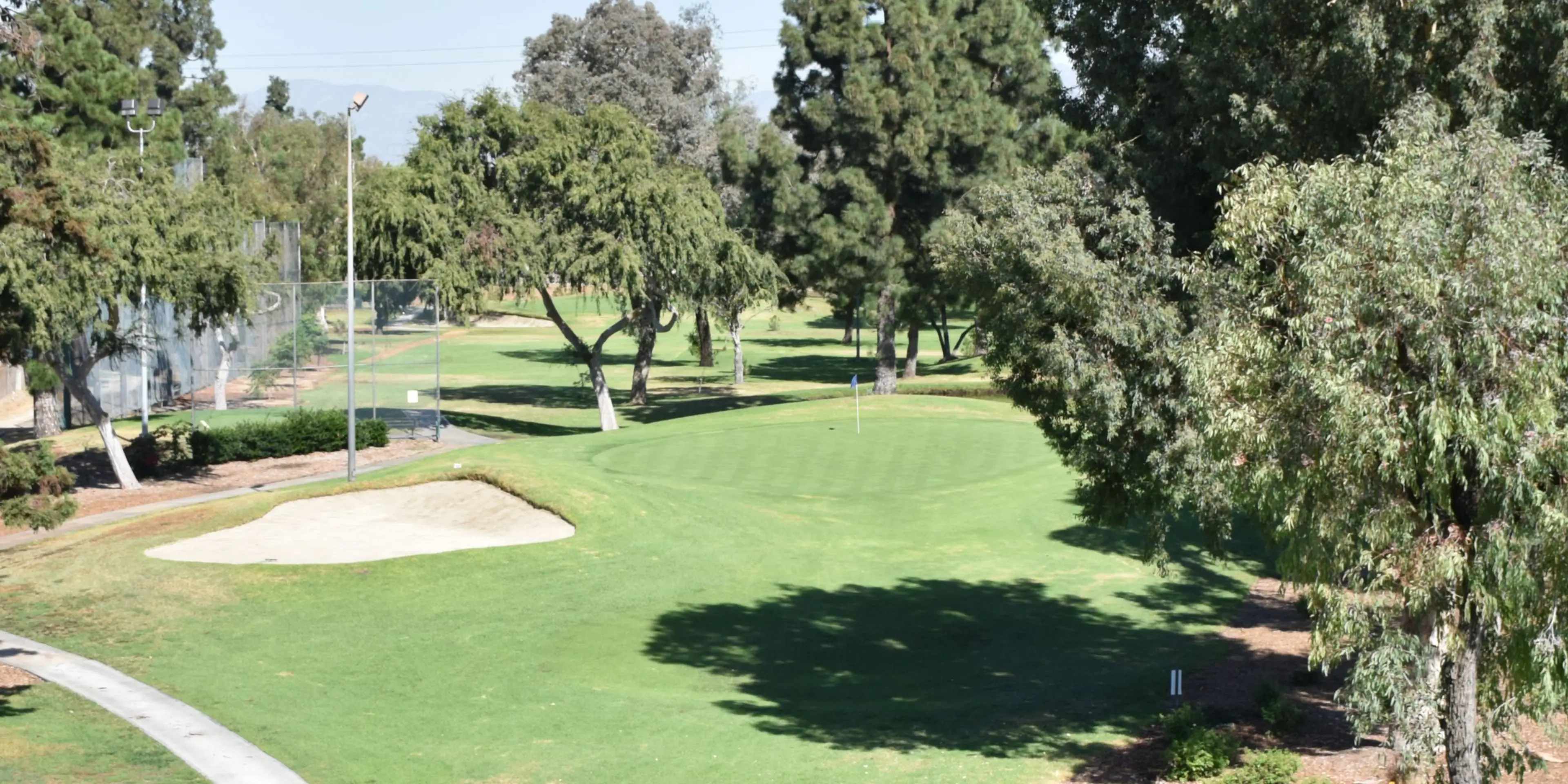 Landscape putting greens and fairway photo of the Pico Rivera Golf Club golf course