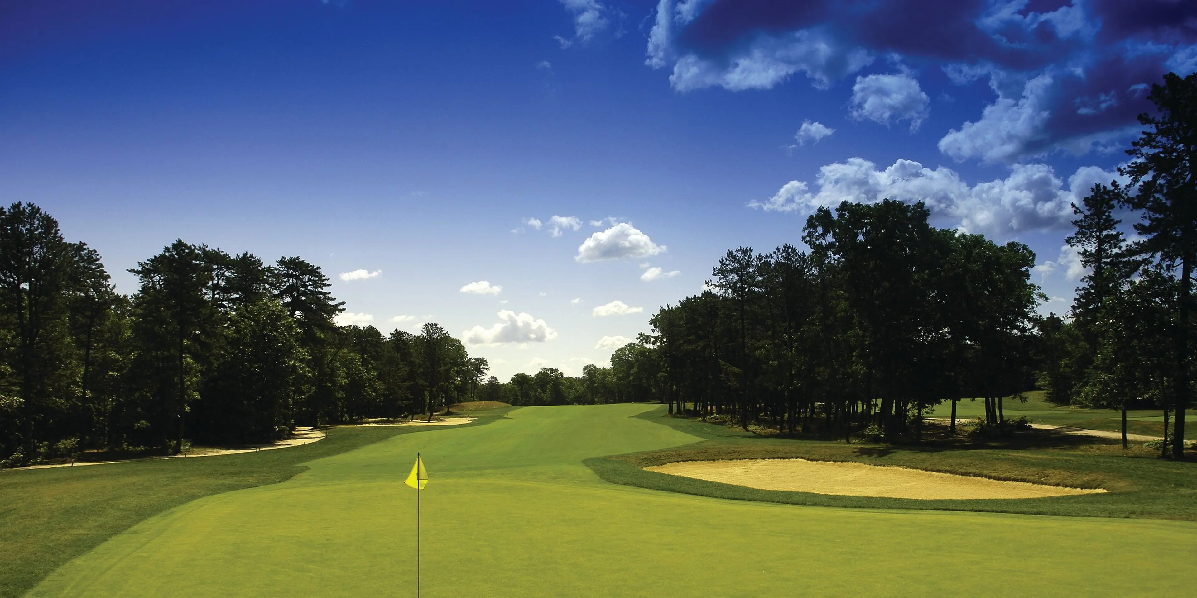 Landscape putting greens and fairway photo of the Pine Ridge Golf Club golf course