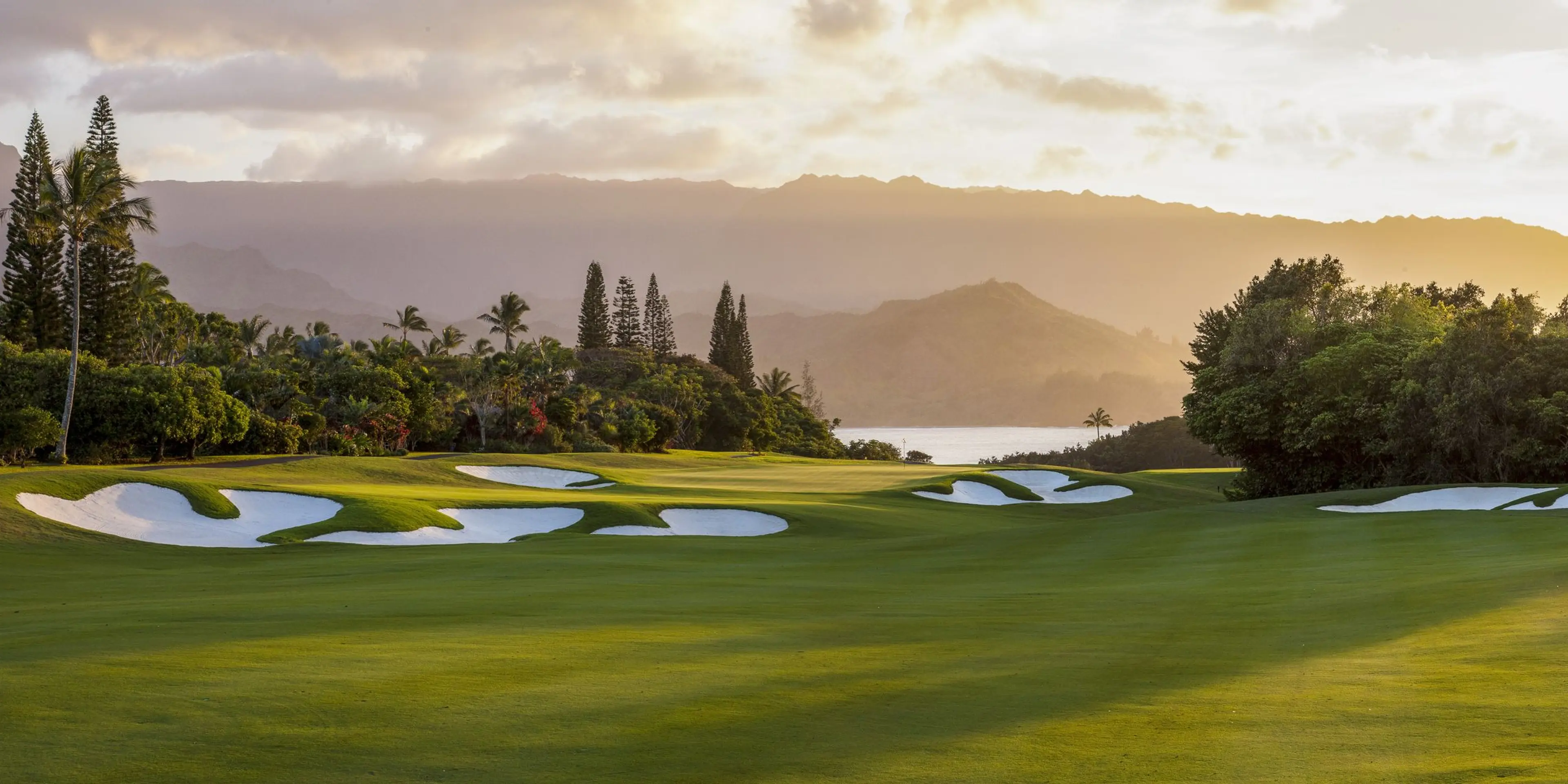 Landscape putting greens and fairway photo of the Princeville Makai Golf Club golf course