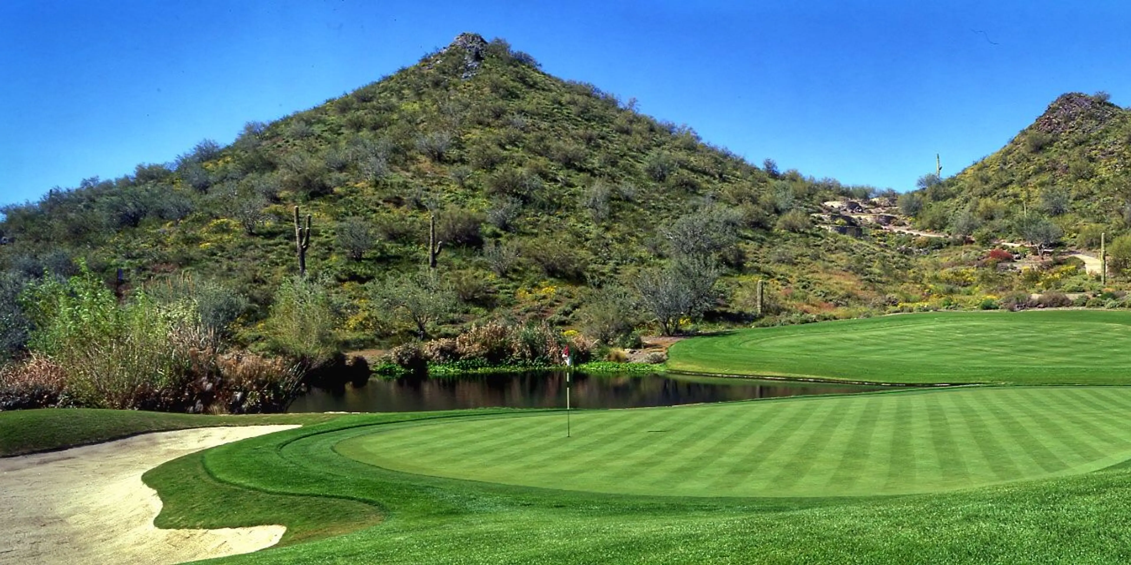 Landscape putting greens and fairway photo of the Quintero Golf Club golf course