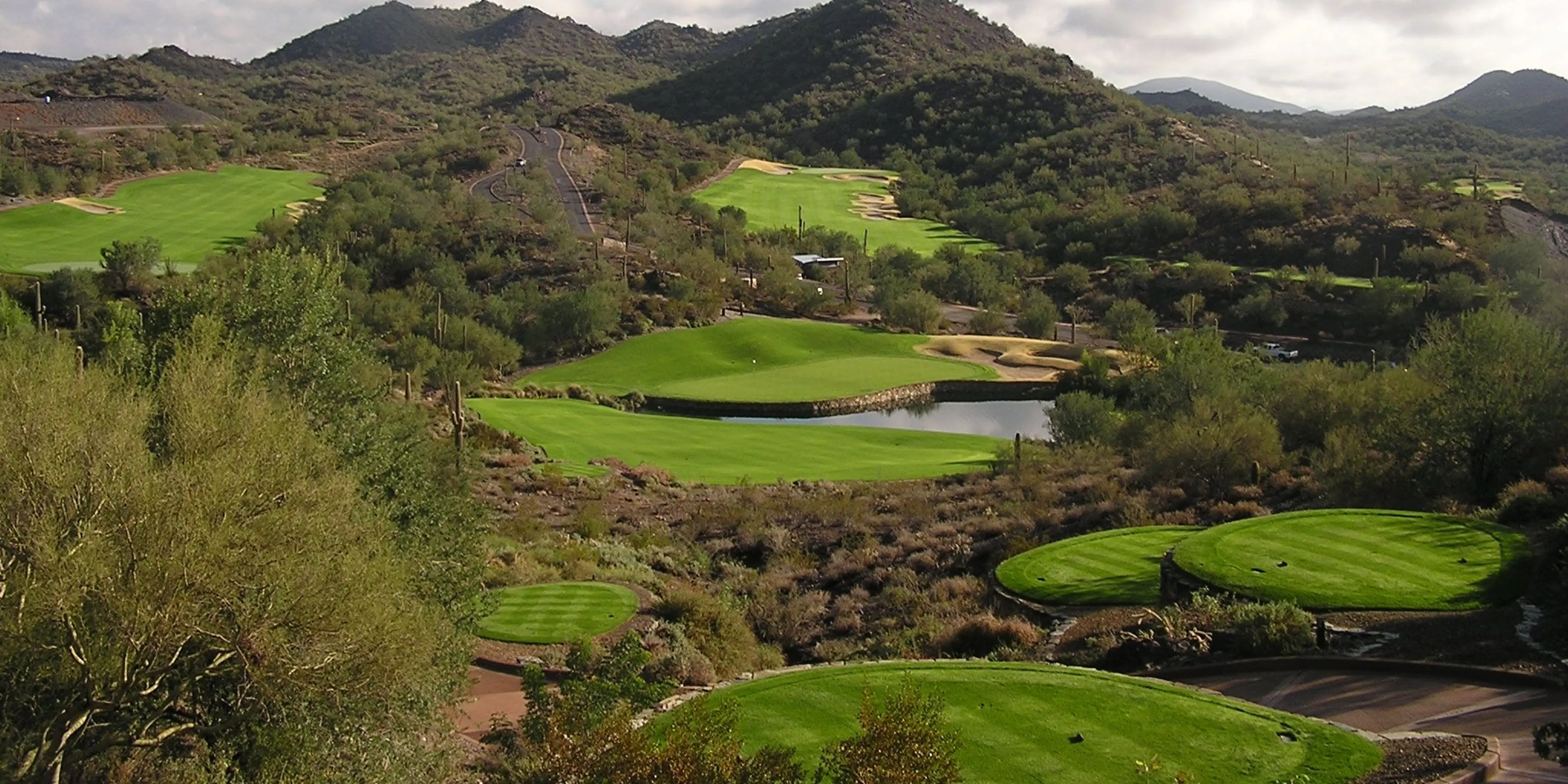 Landscape putting greens and fairway photo of the Quintero Golf Club golf course