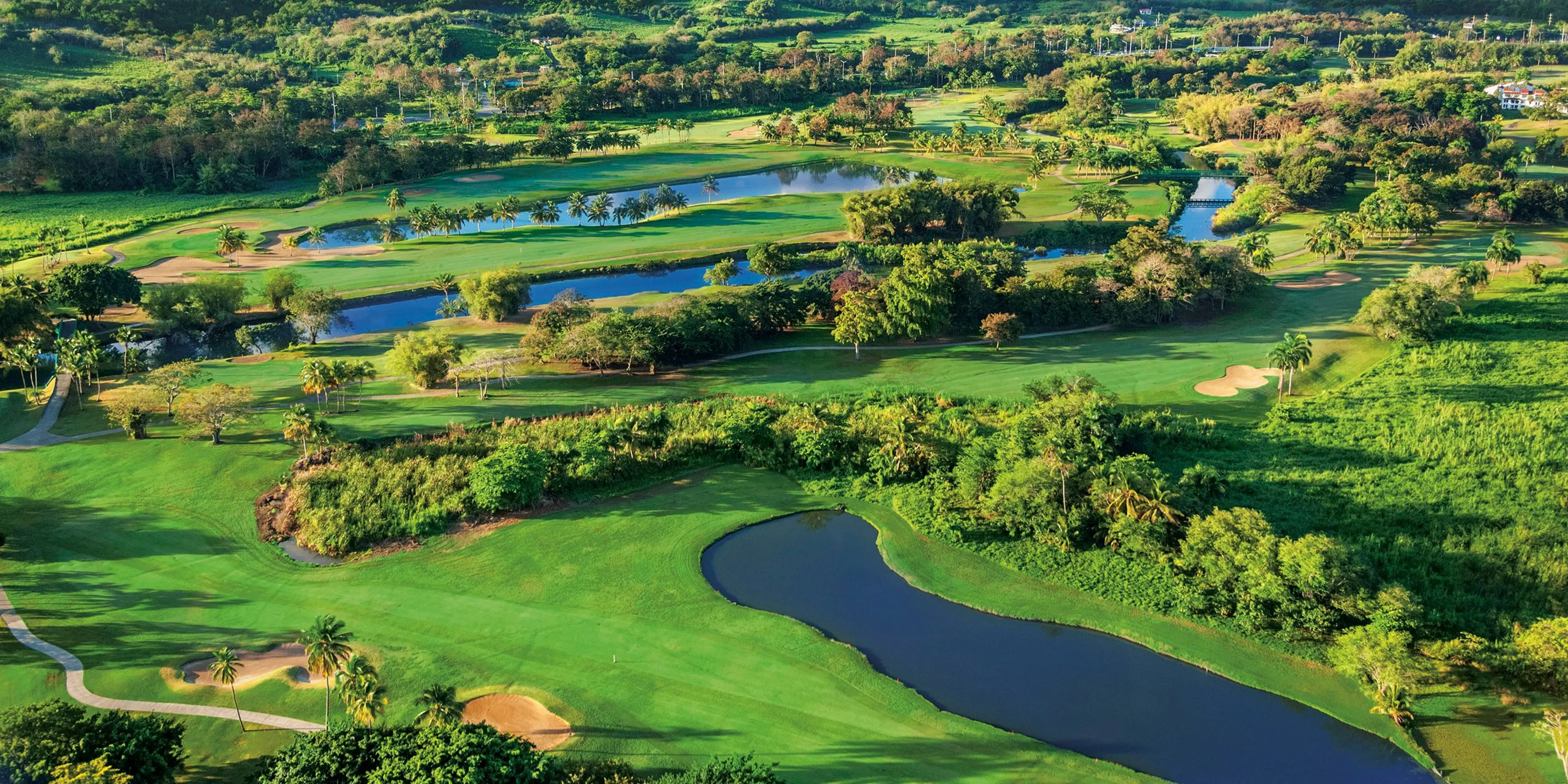 Landscape putting greens and fairway photo of the Rio Mar Country Club golf course