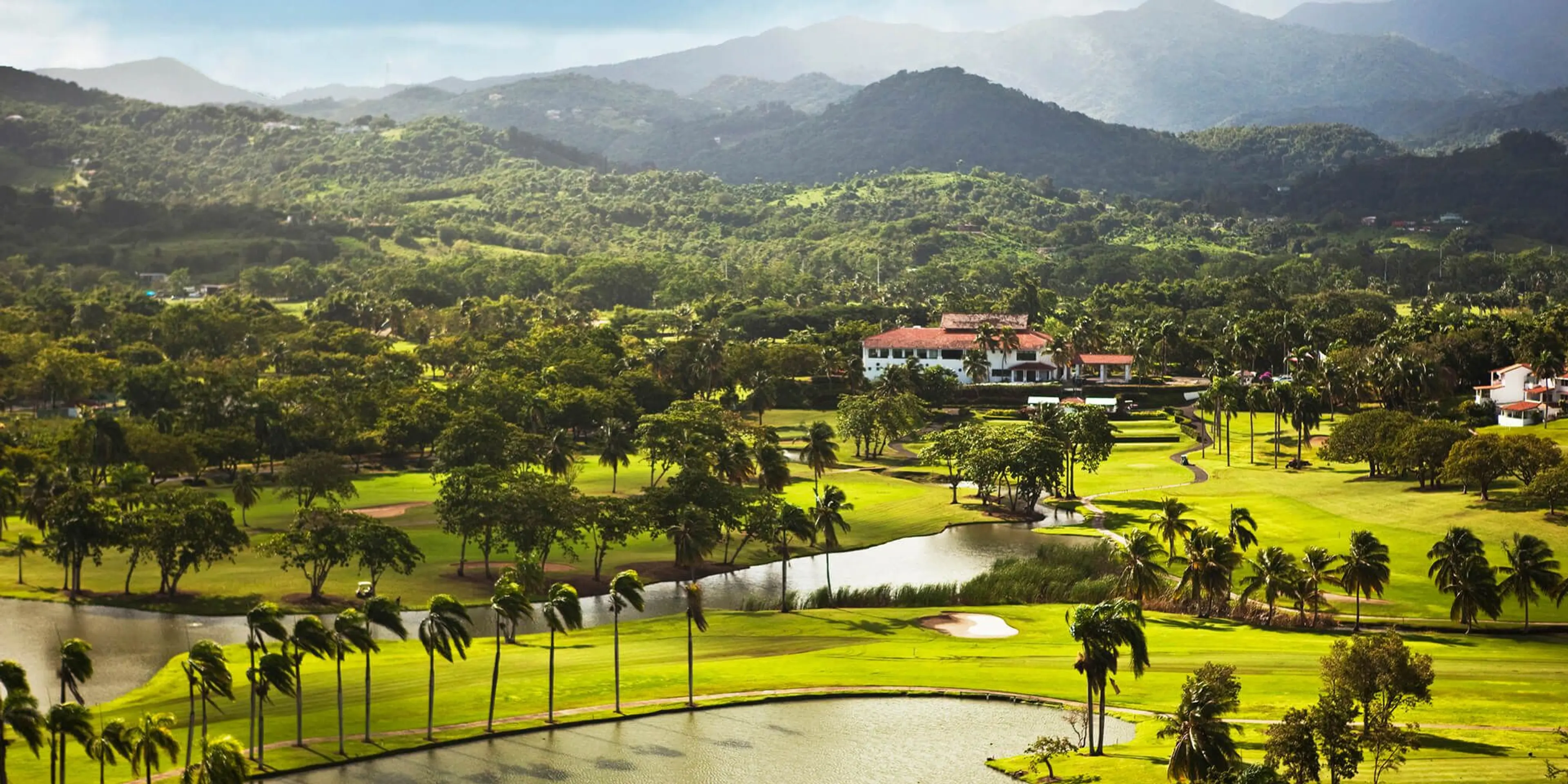 Landscape putting greens and fairway photo of the Rio Mar Country Club golf course