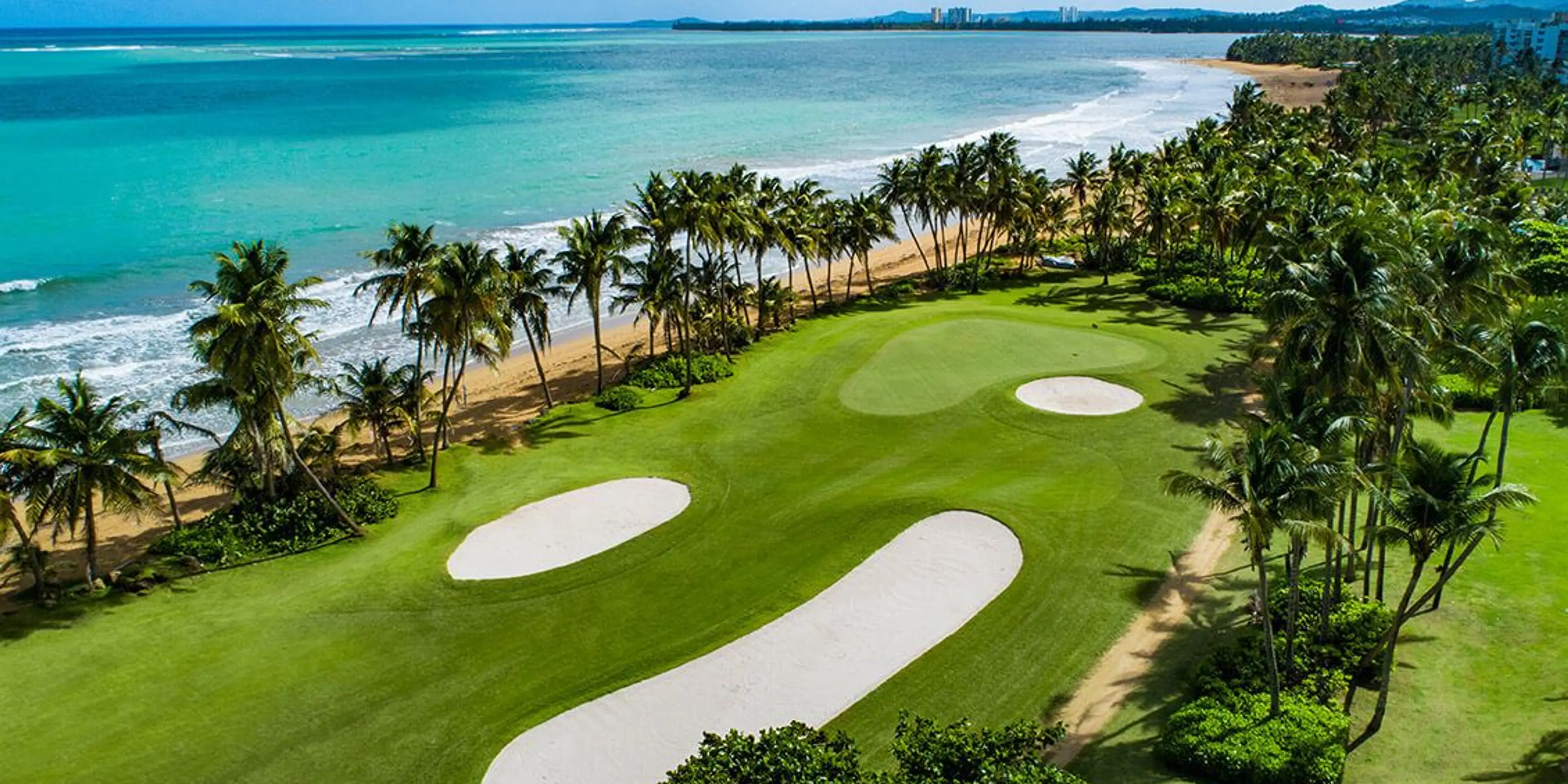 Landscape putting greens and fairway photo of the Rio Mar Country Club golf course