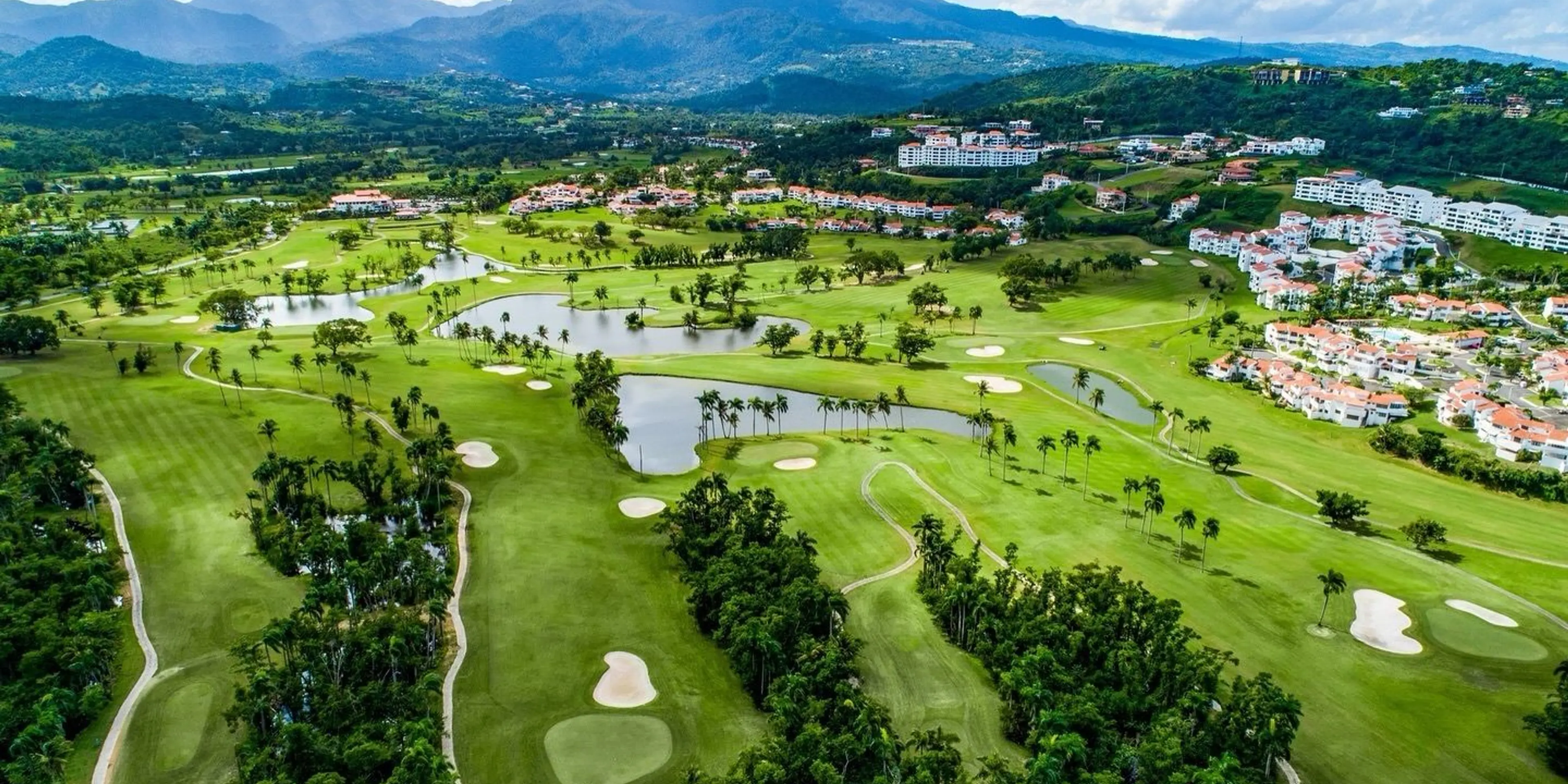Landscape putting greens and fairway photo of the Rio Mar Country Club golf course