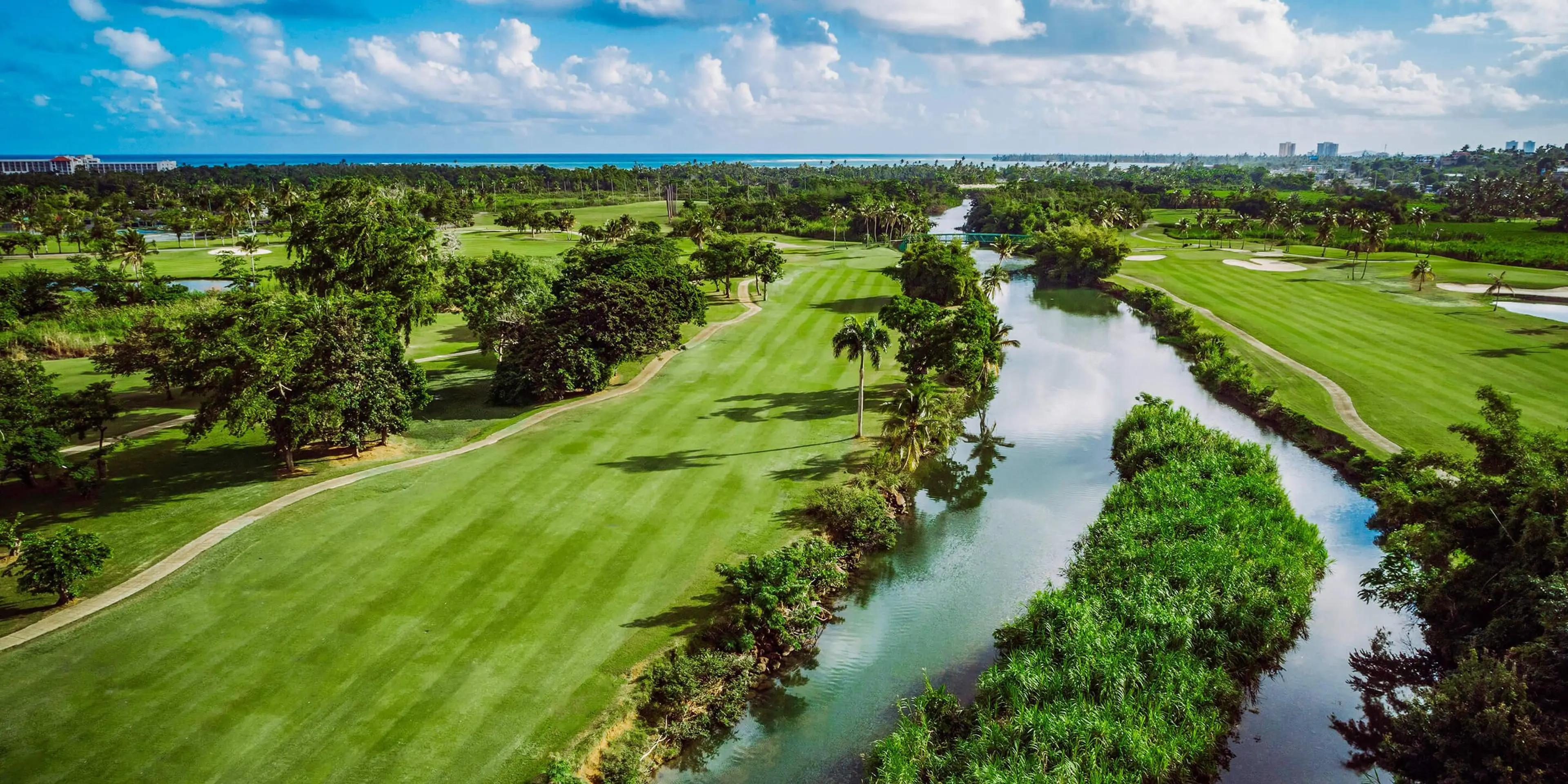 Landscape putting greens and fairway photo of the Rio Mar Country Club golf course