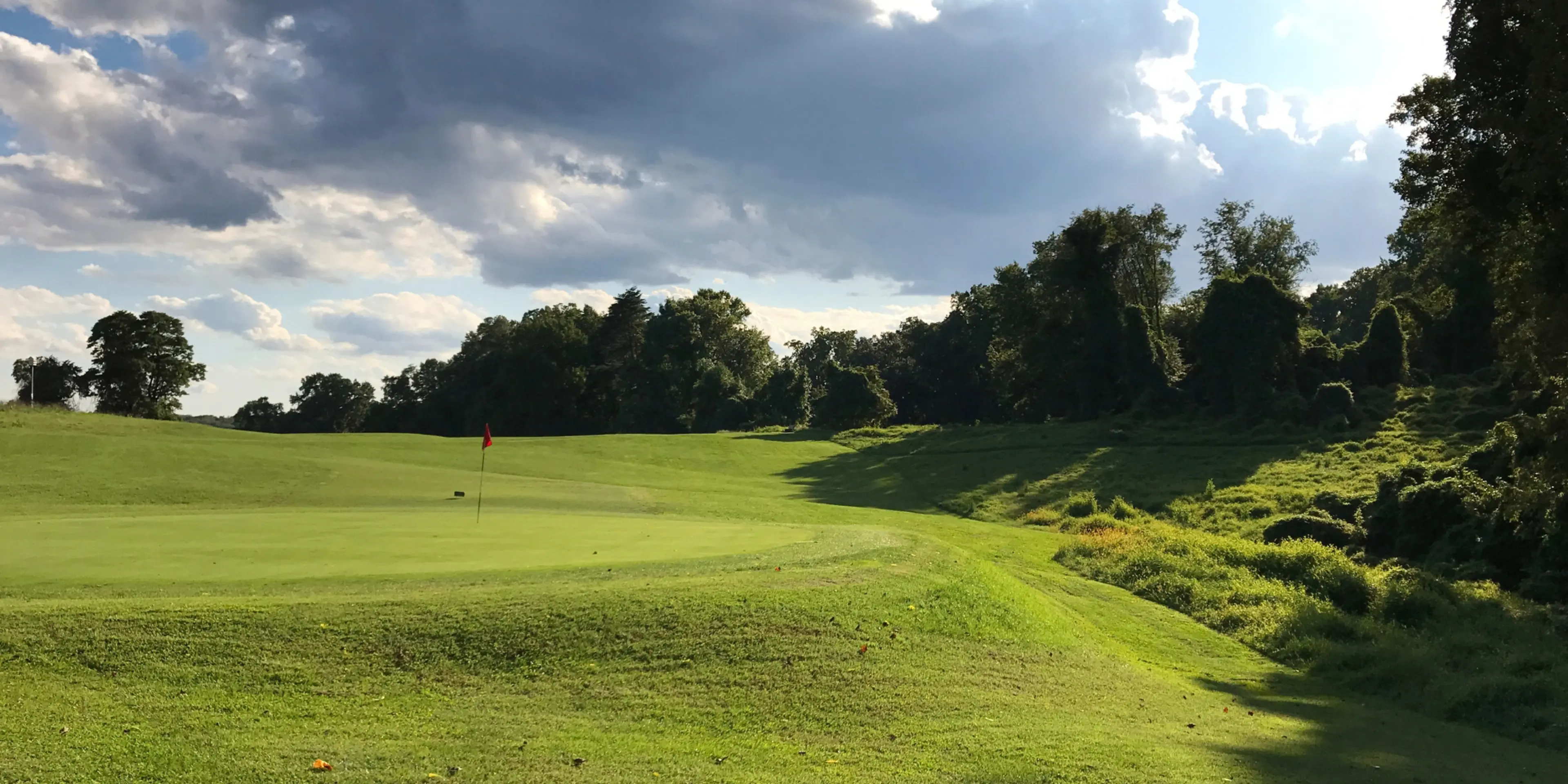 Landscape putting greens and fairway photo of the Rock Creek Park Golf Course golf course