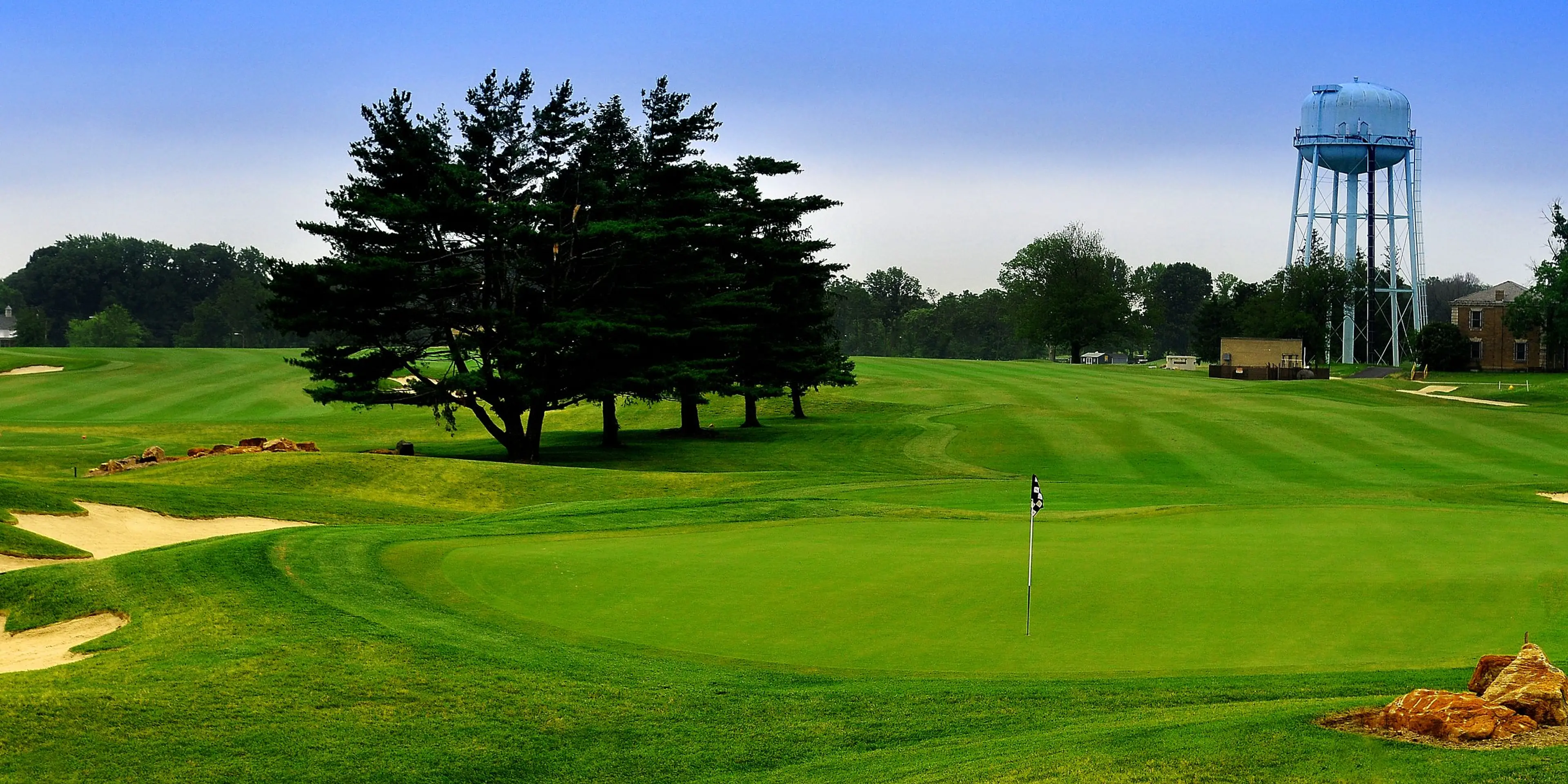 Landscape putting greens and fairway photo of the Rock Manor Golf Course golf course