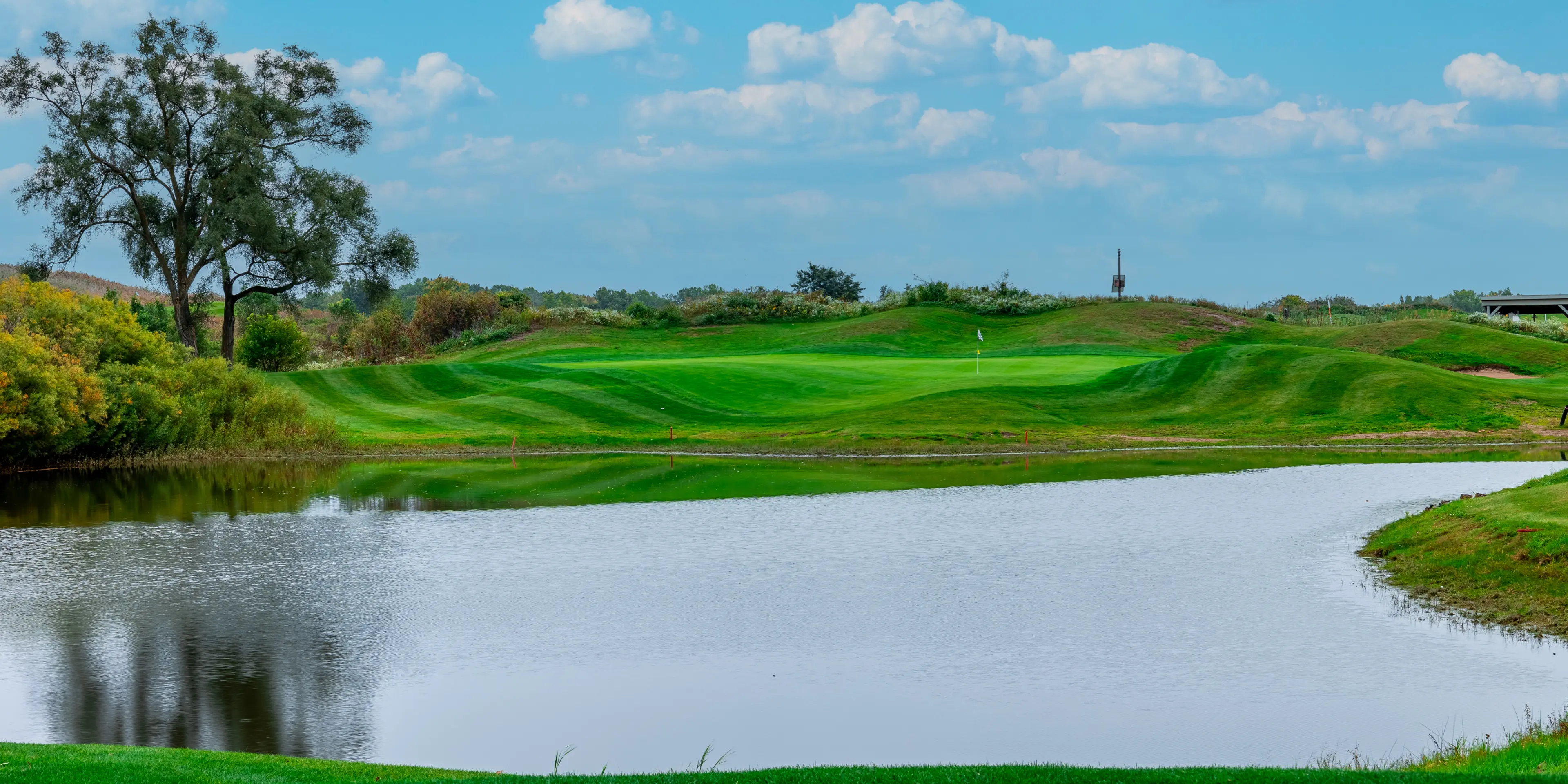 Landscape putting greens and fairway photo of the Sanctuary Lake Golf Course golf course