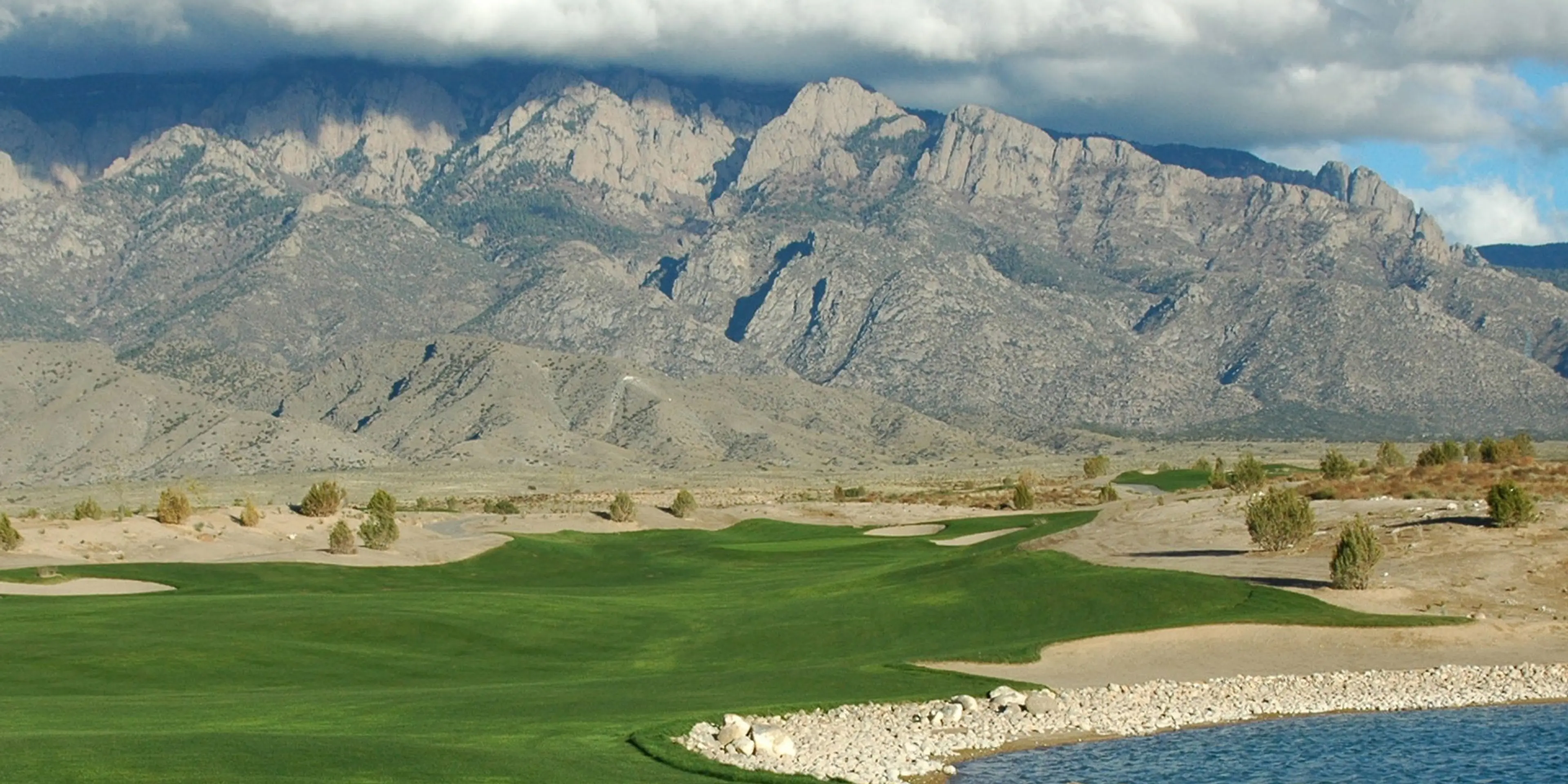 Landscape putting greens and fairway photo of the Sandia Golf Club golf course