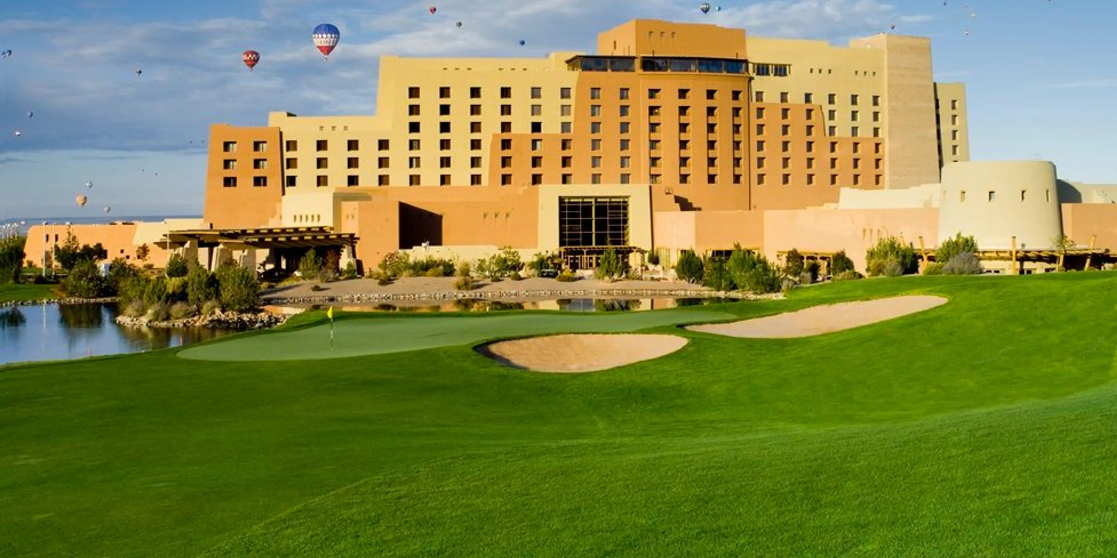 Landscape putting greens and fairway photo of the Sandia Golf Club golf course